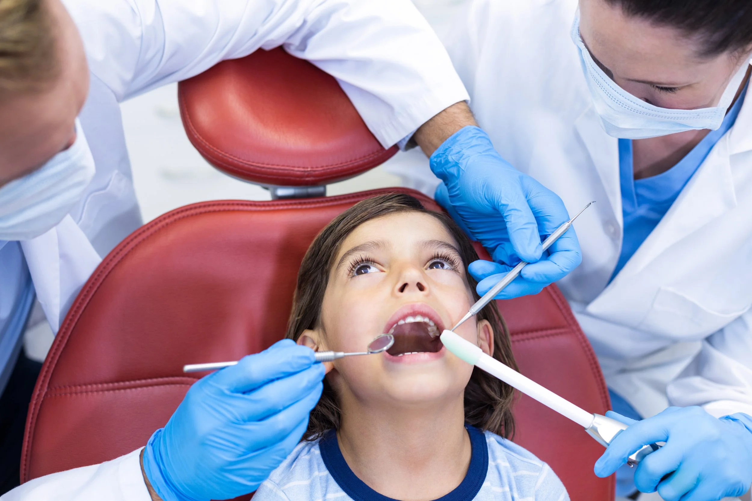 dentists-examining-young-patient-in-dental-clinic-2021-08-28-16-44-41-utc.jpg
