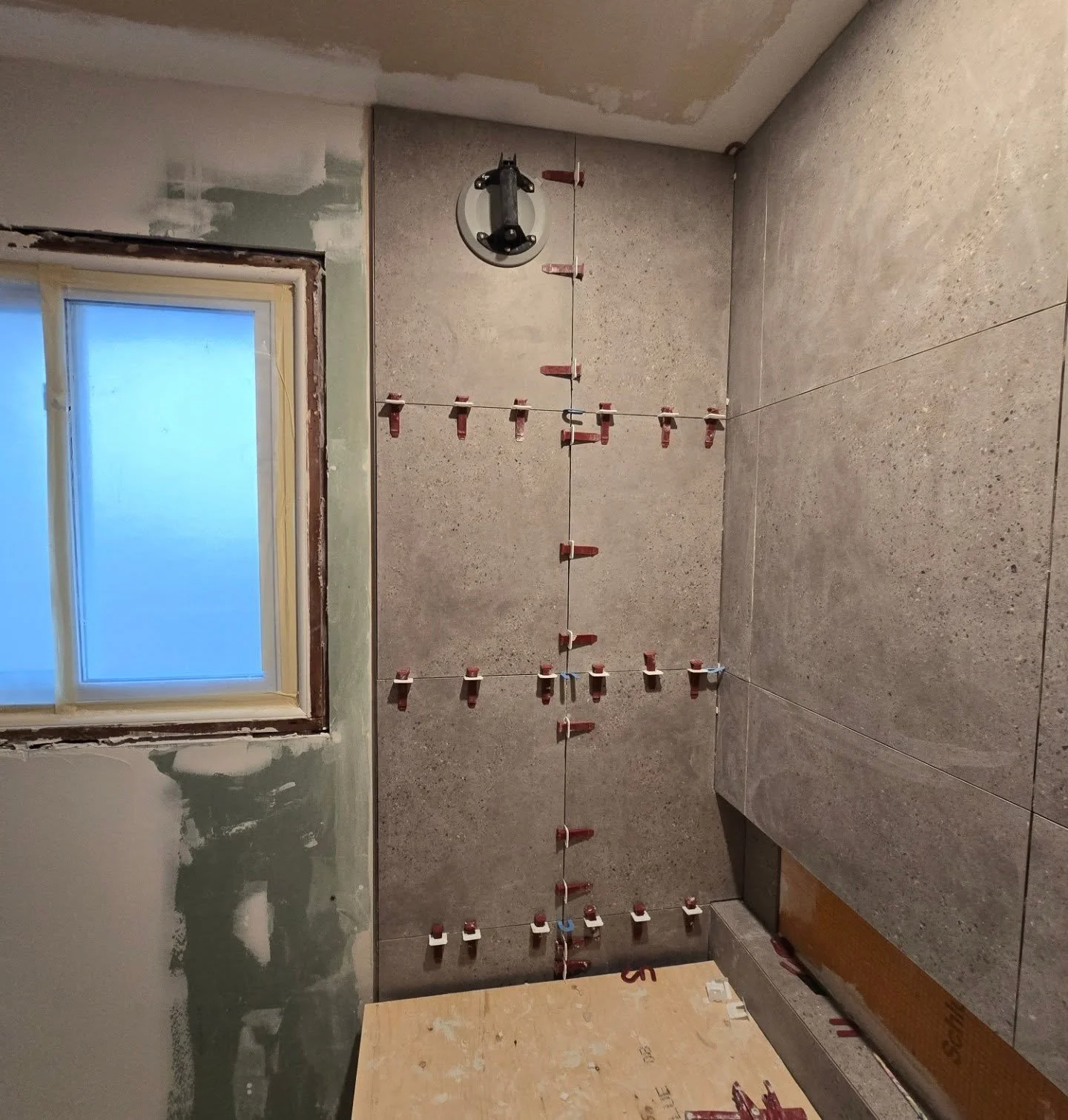 This bathroom is a work in progress! Curveballs include thick concrete walls, a moldy bath, asbestos tiles, and copper drains. But I'm loving the wall-to-wall design and mitered niche - it's going to be beautiful!

Tiles, tub, toilet, lighting, &amp;