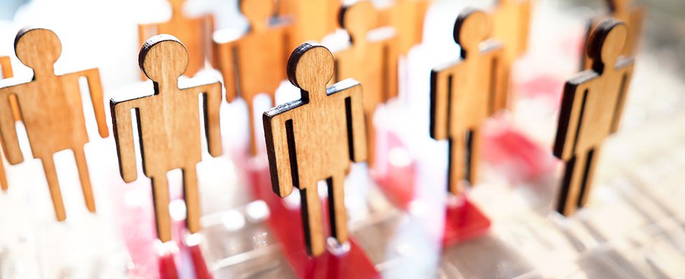 wooden figures of people standing in rows