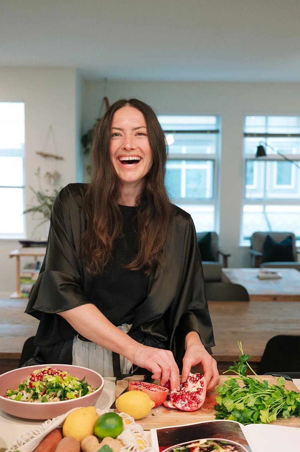 Jess Kirby preparing fresh food in a kitchen.