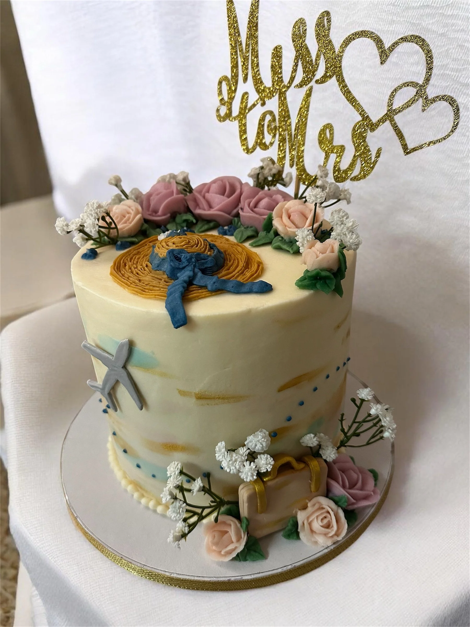 7" 3- layer torted bridal shower white cake; buttercream frosting with handmade fondant decorations, buttercream roses, faux baby's breath.  $200