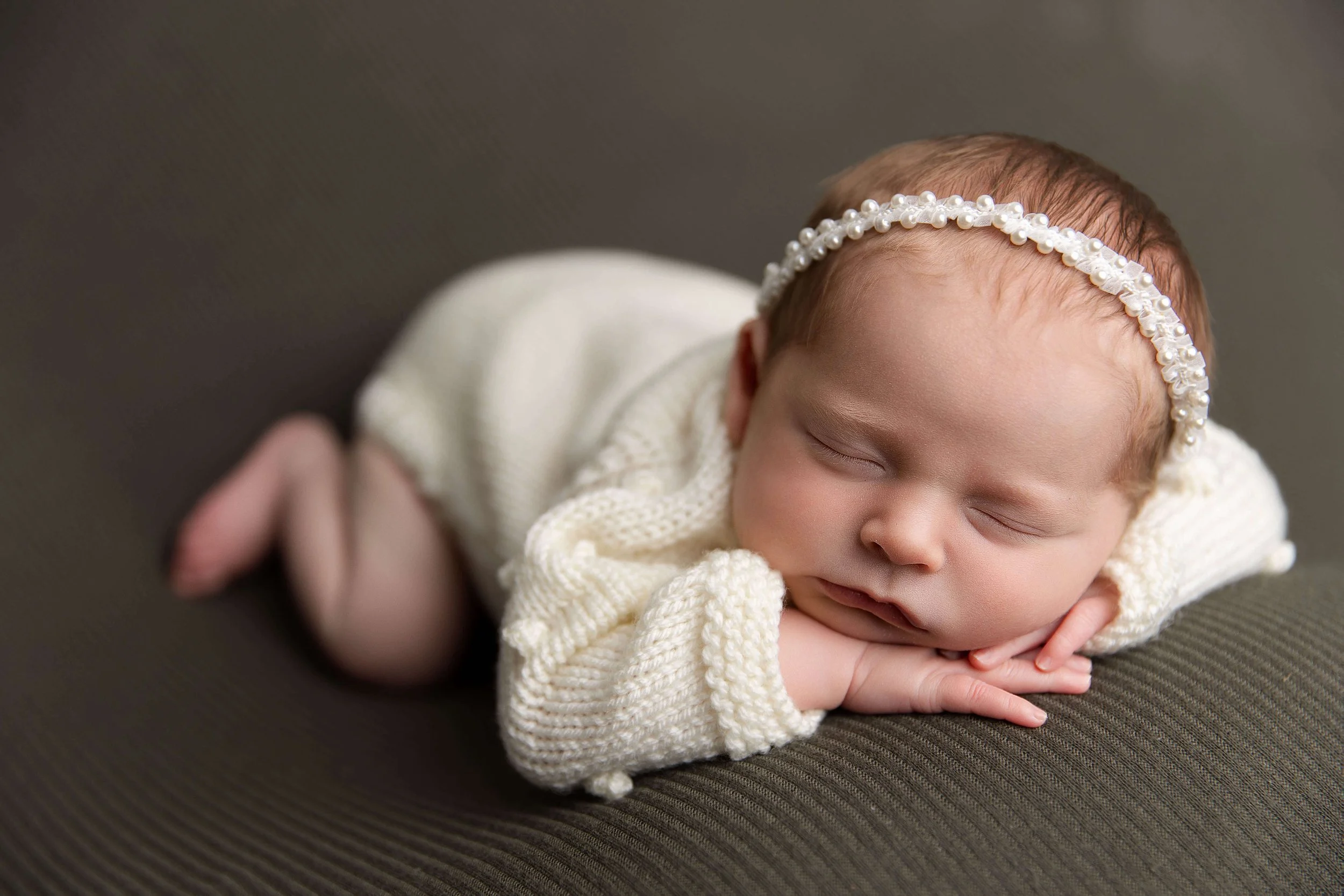 Timeless posed newborn photo created by a Frisco TX newborn photographer in a professional studio
