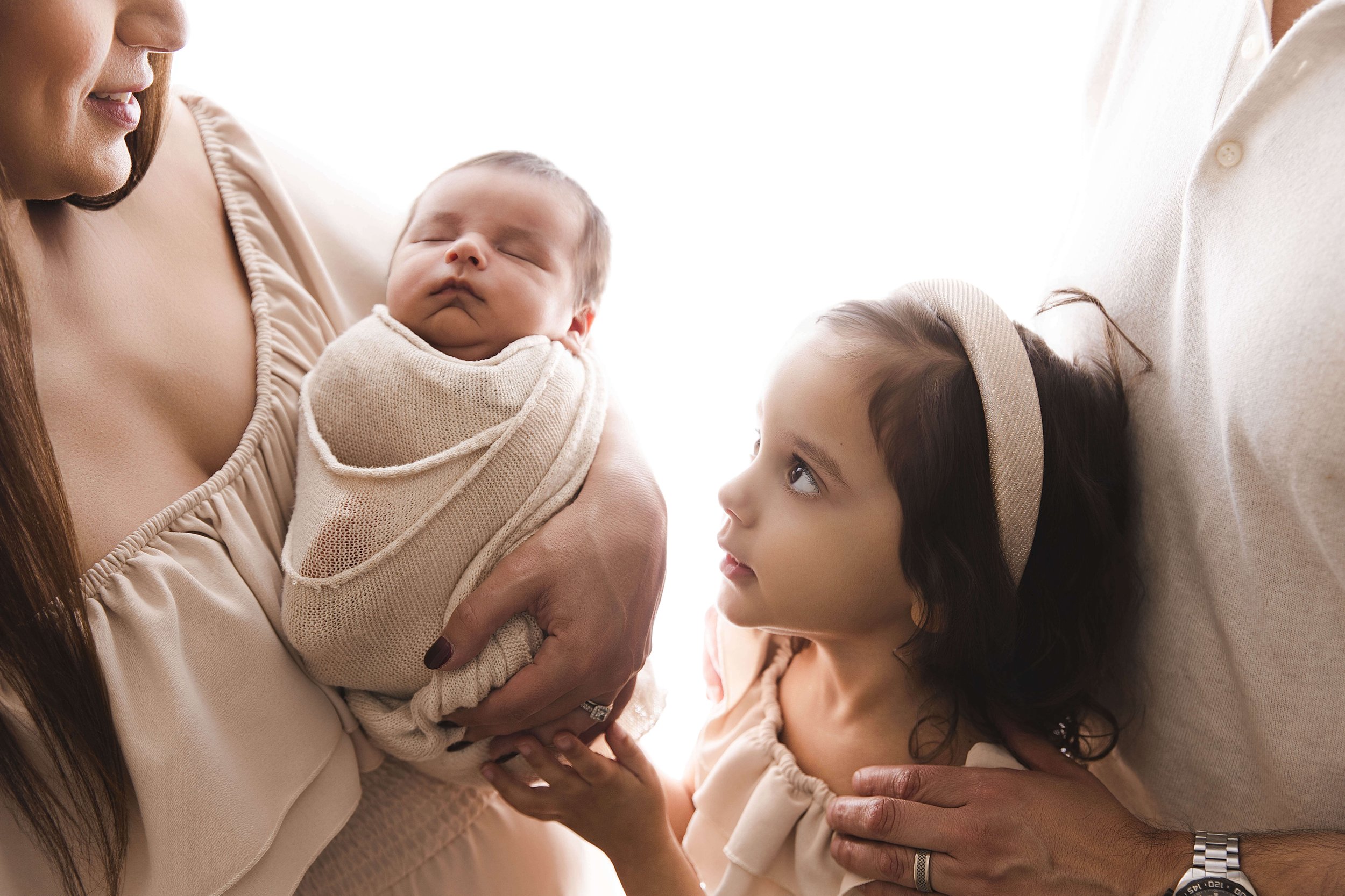 Close up of sister and baby brother backlit