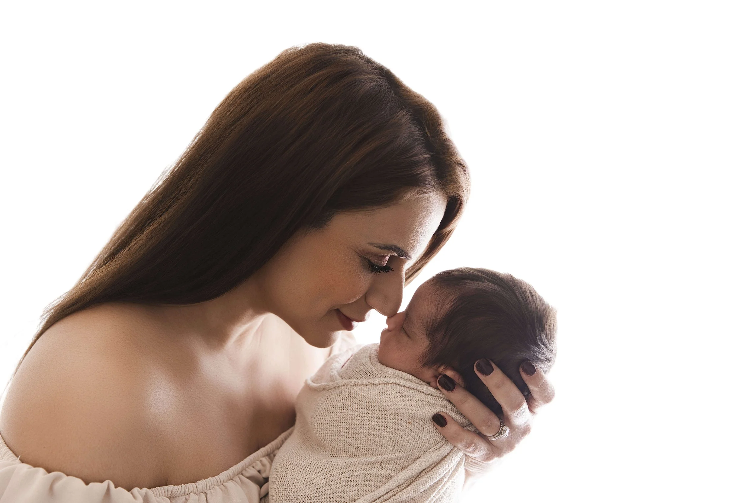 mom touching her nose to newborn baby