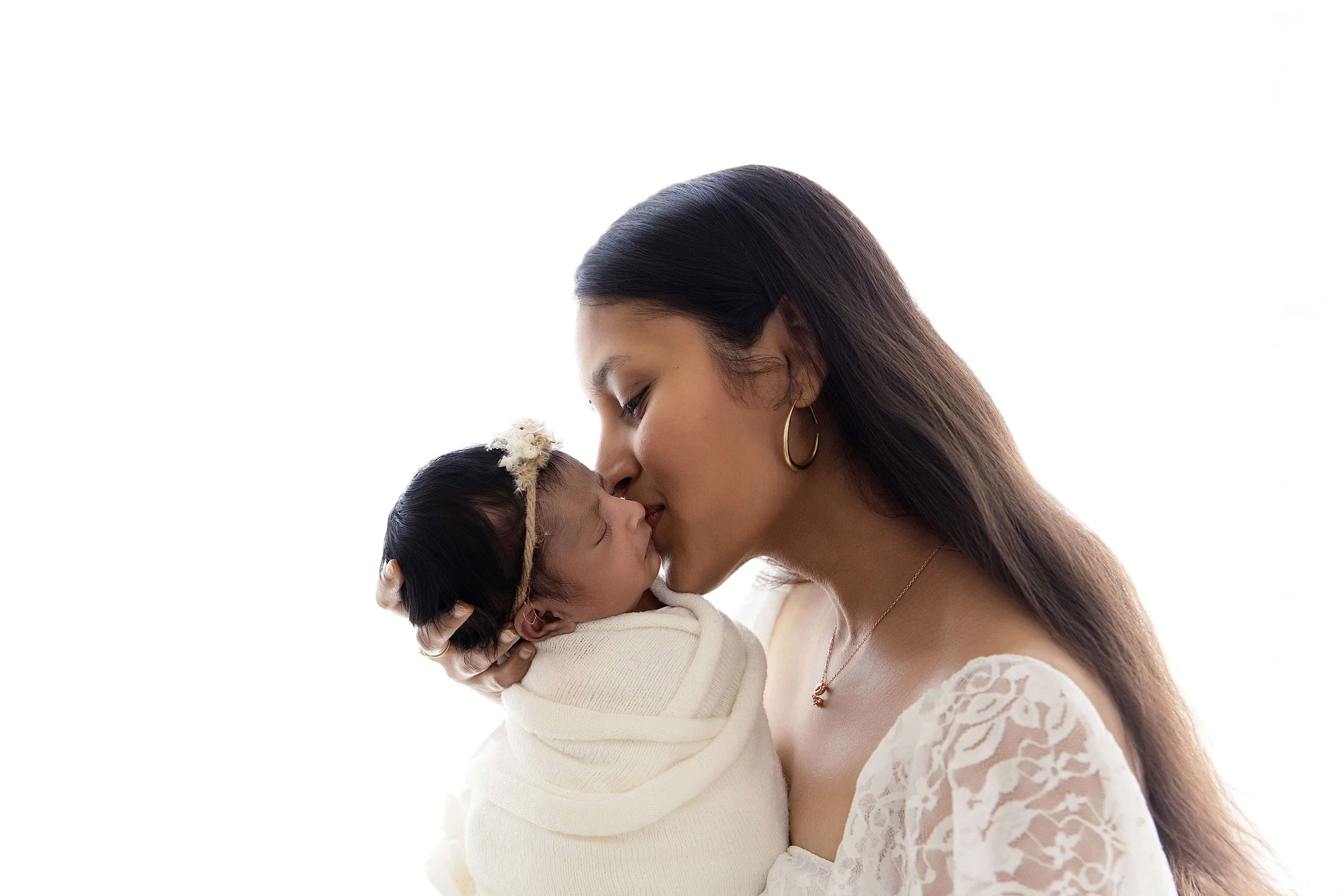 mom kissing baby's cheek