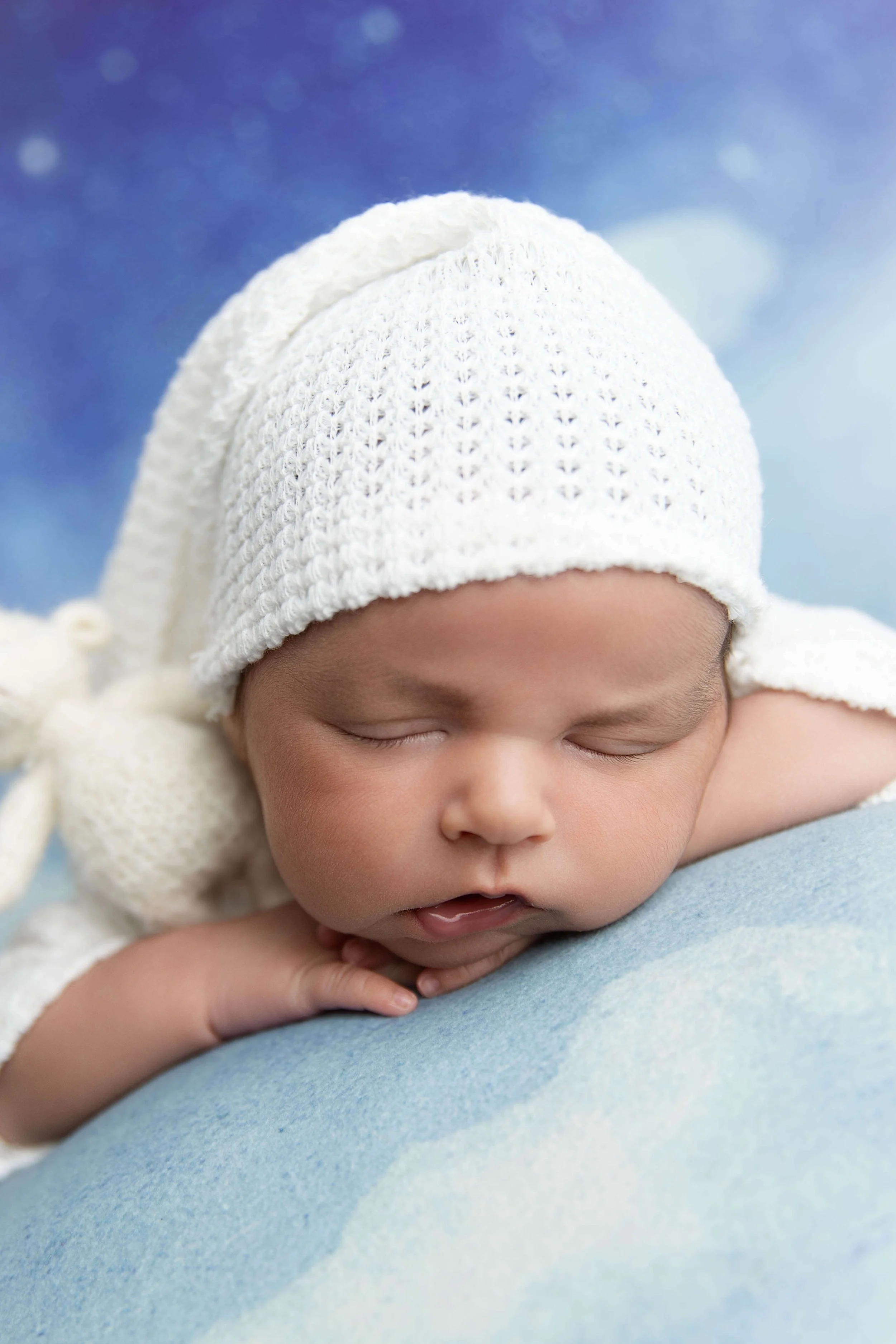newborn baby chin on hands