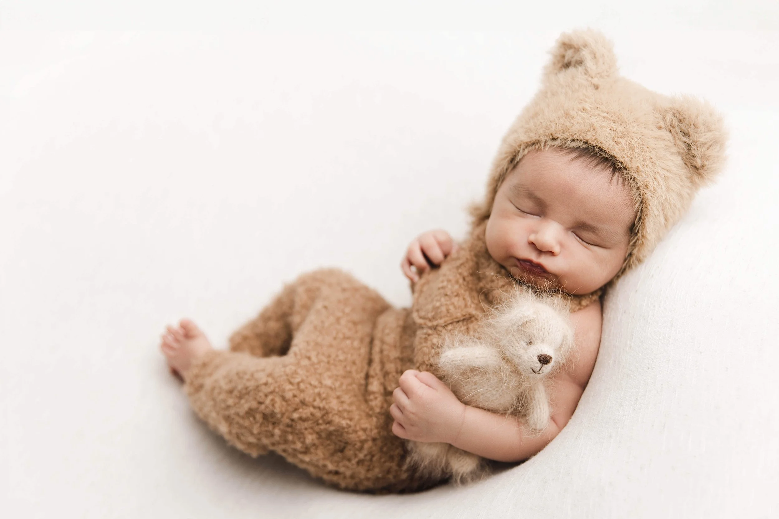 baby boy in a brown teddy bear outfit