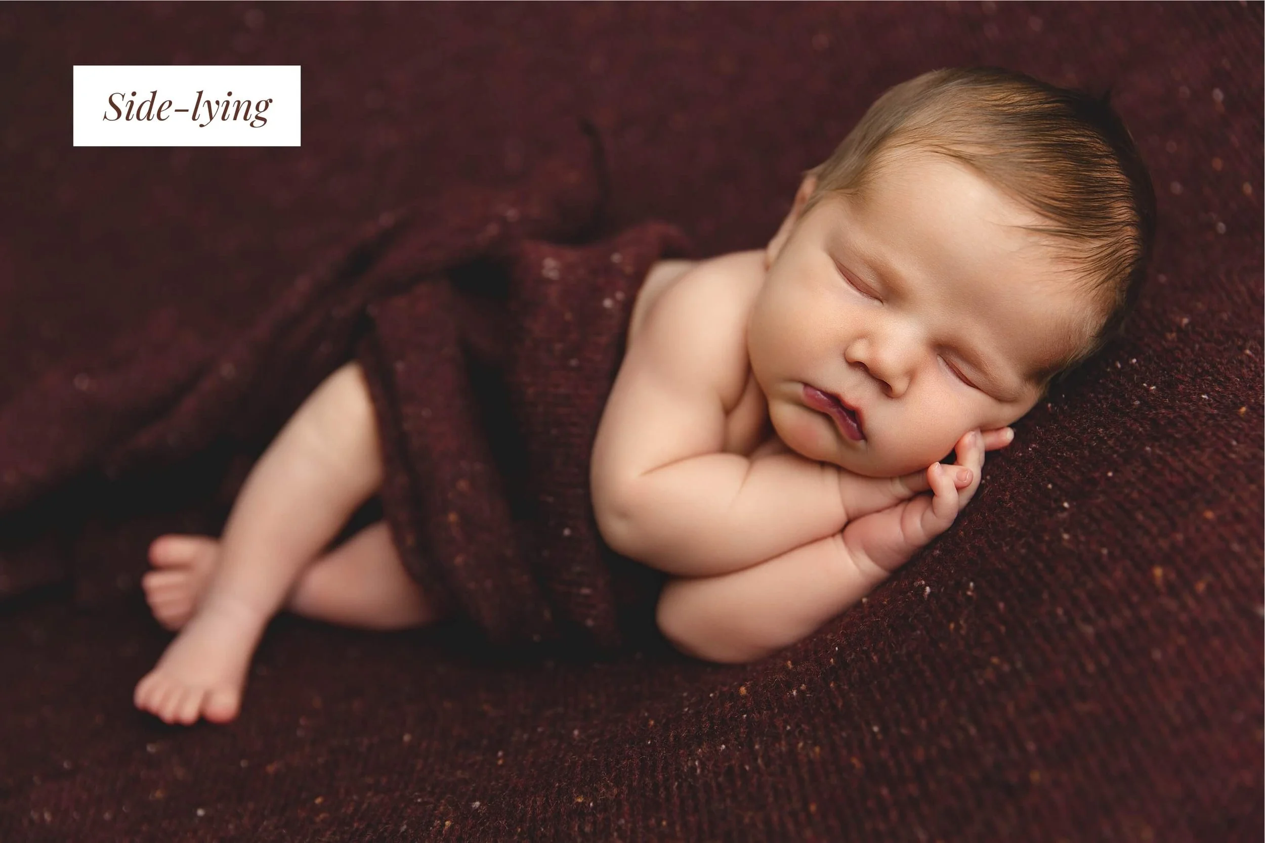 Newborn baby boy laying on its side