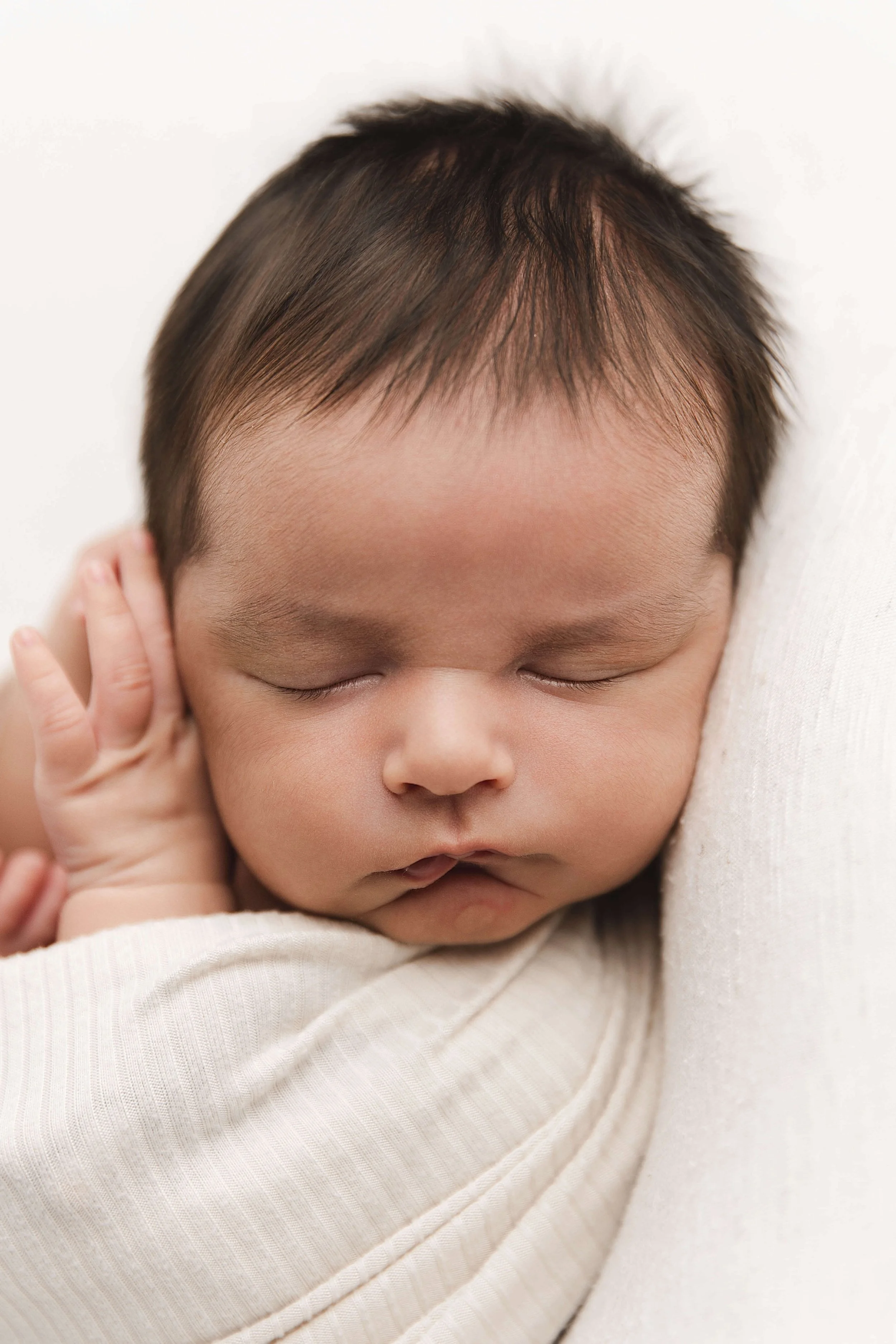 close-up of baby wrapped in a neutral look