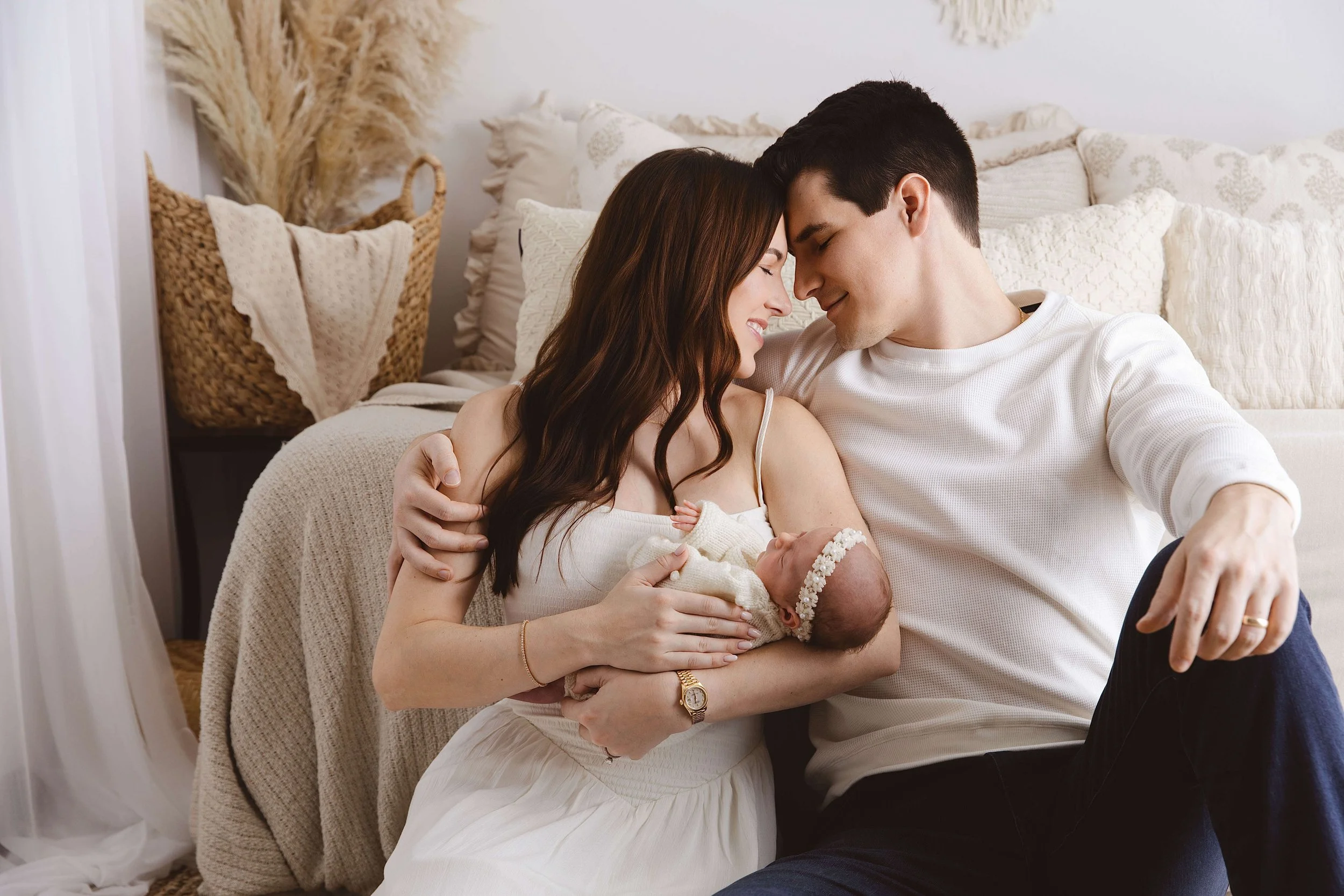 Soft light photo of mother and father emotional moment with baby