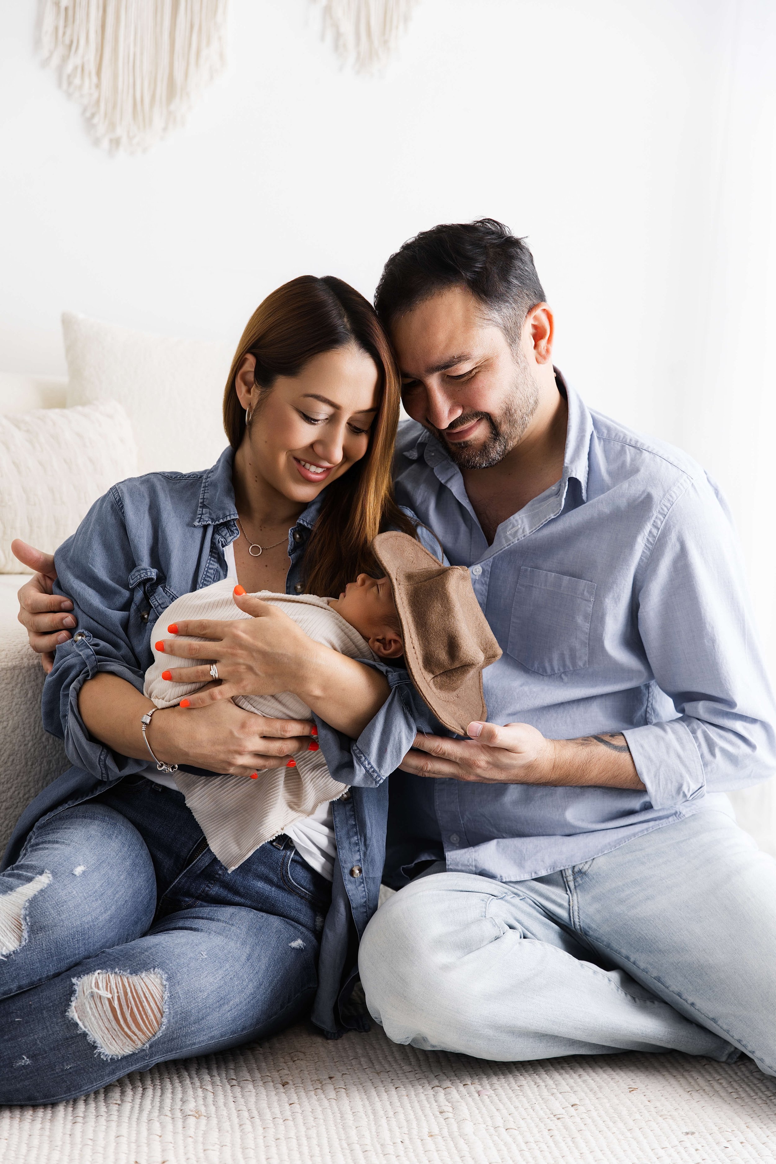 newborn baby wearing cowboy hat family photo