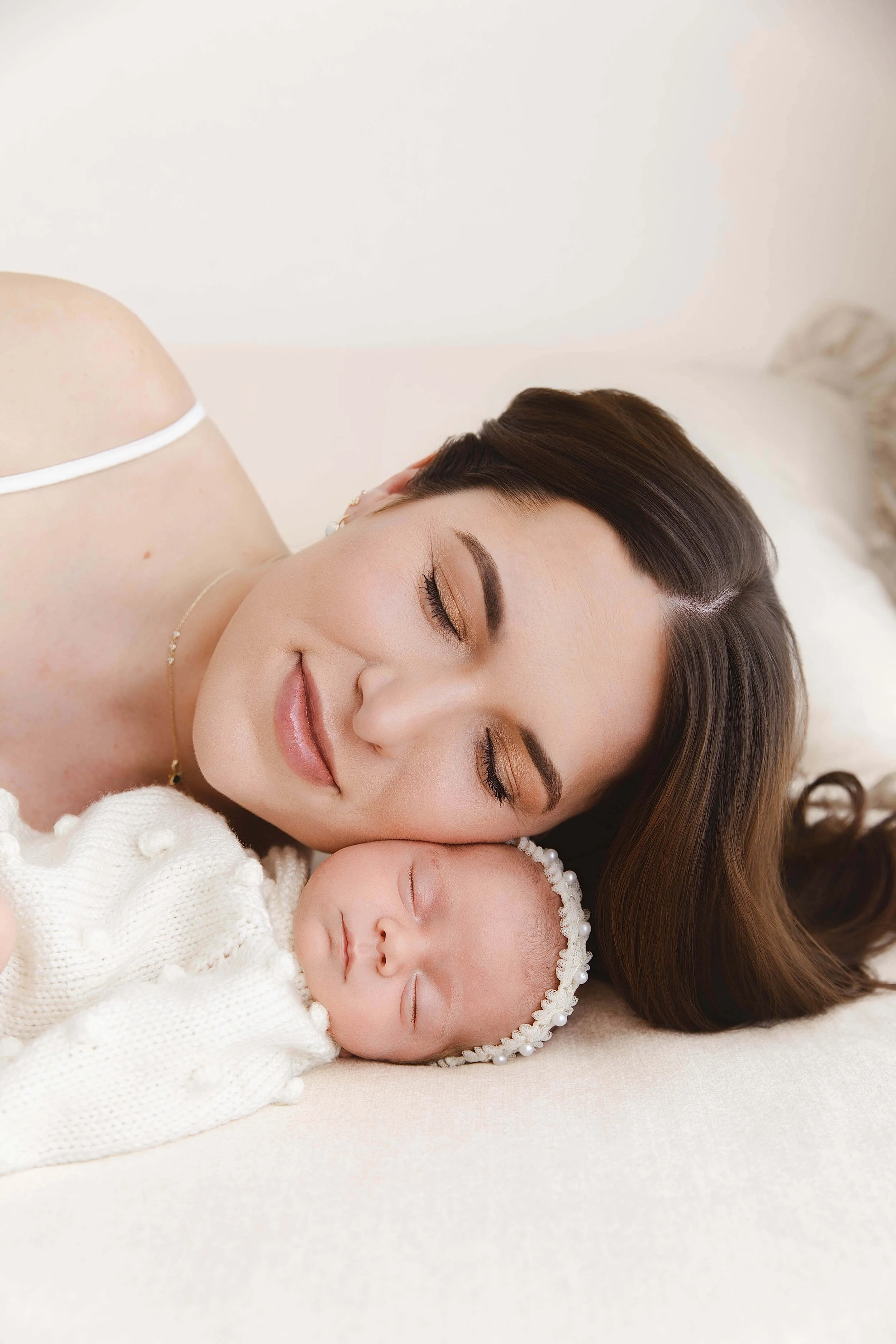 Mother sleeping next to her baby girl