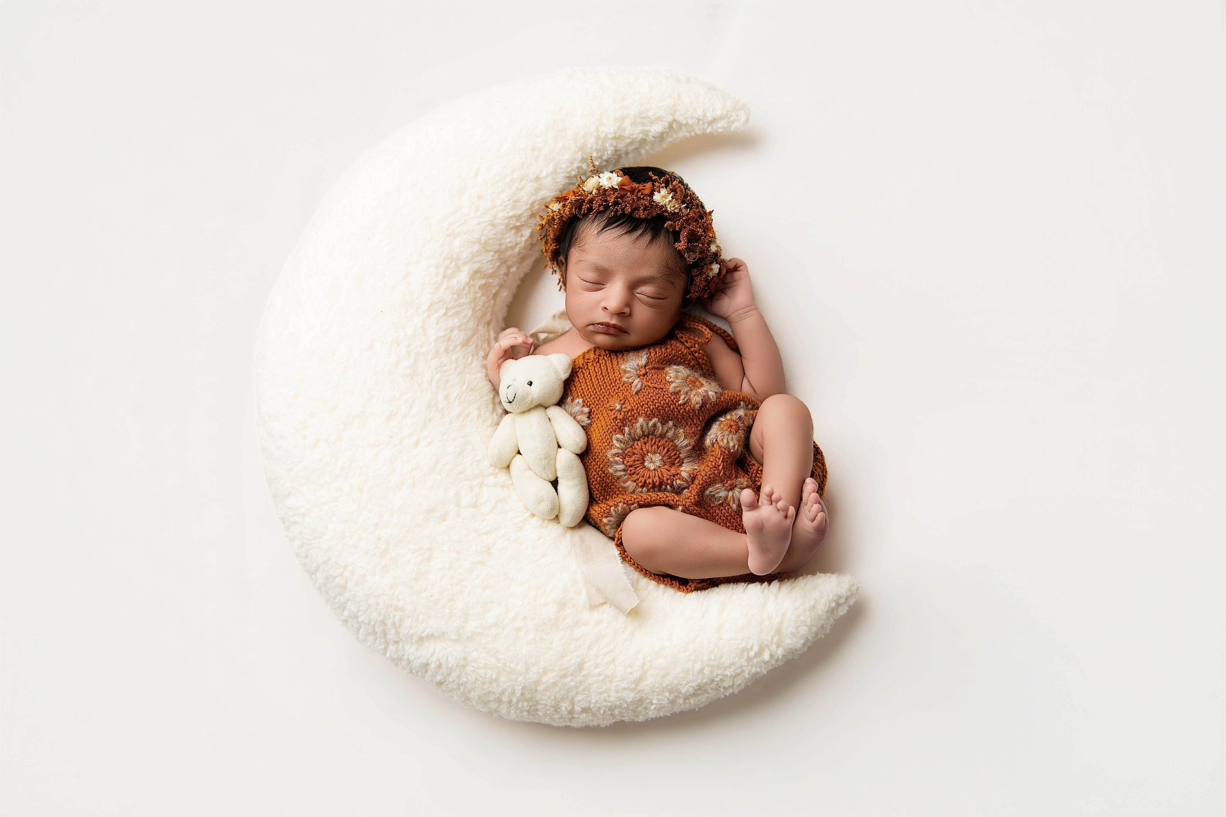 baby wearing knitted out in a moon prop