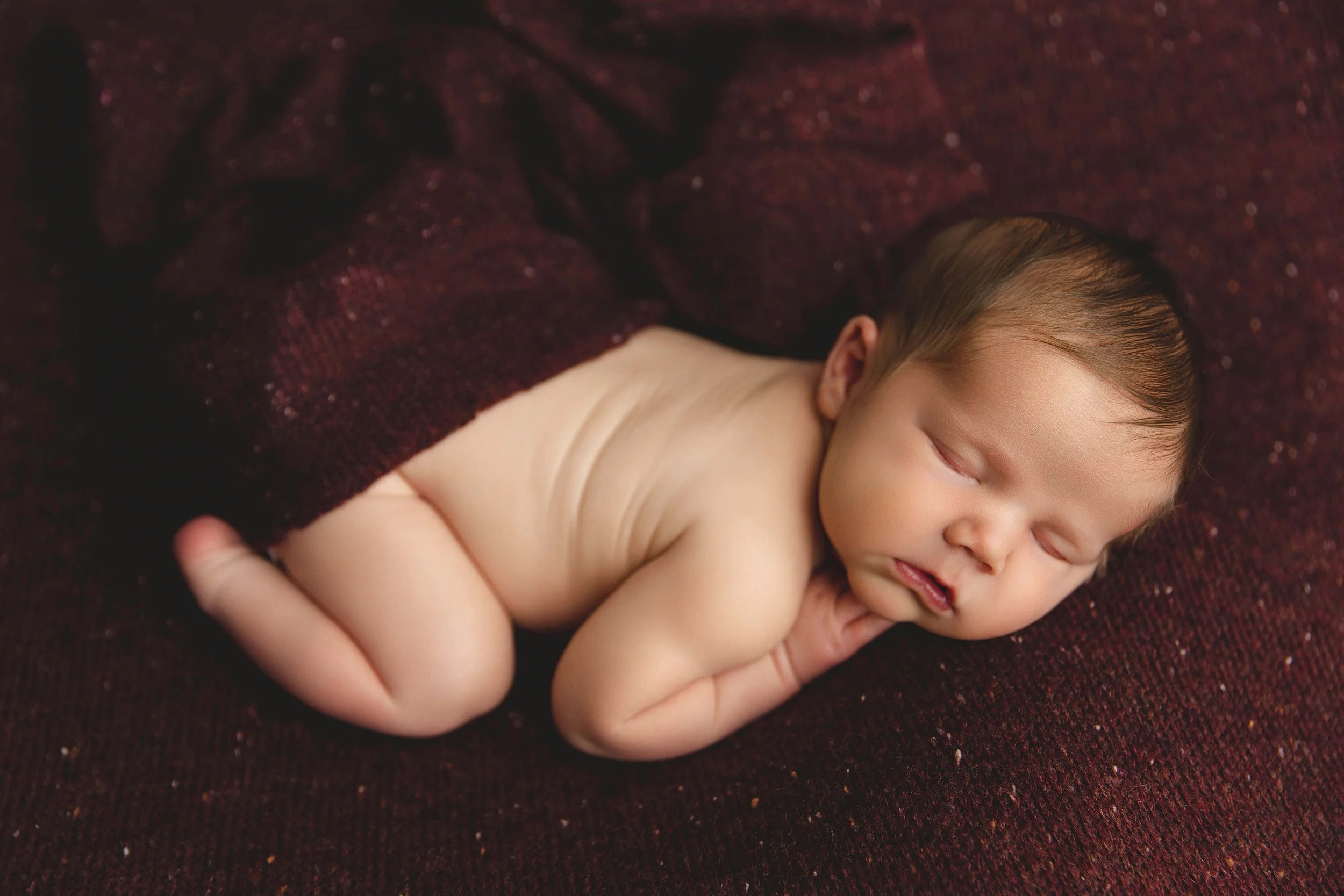 Newborn Baby Boy Cuddled Up