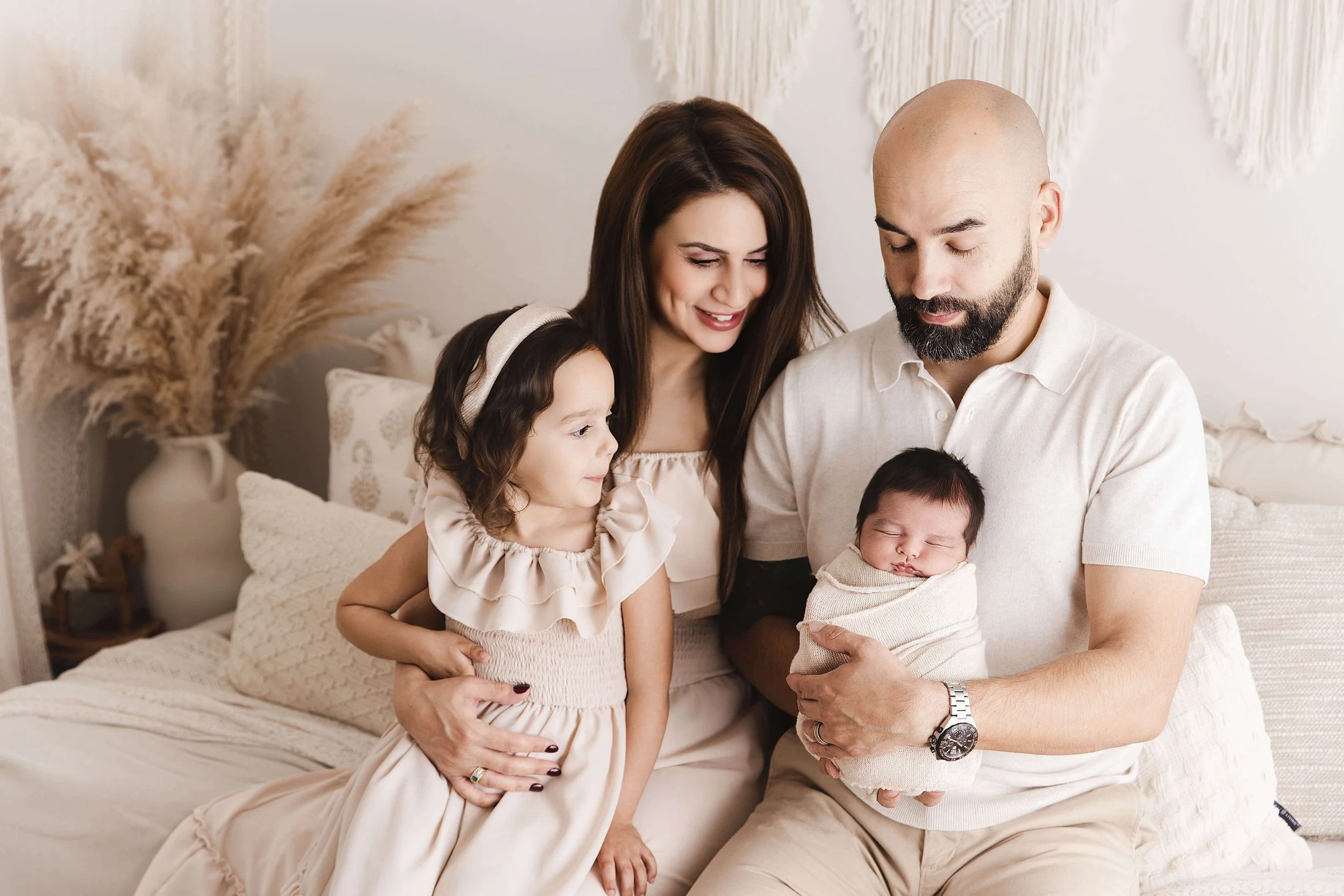 Family watching over newborn