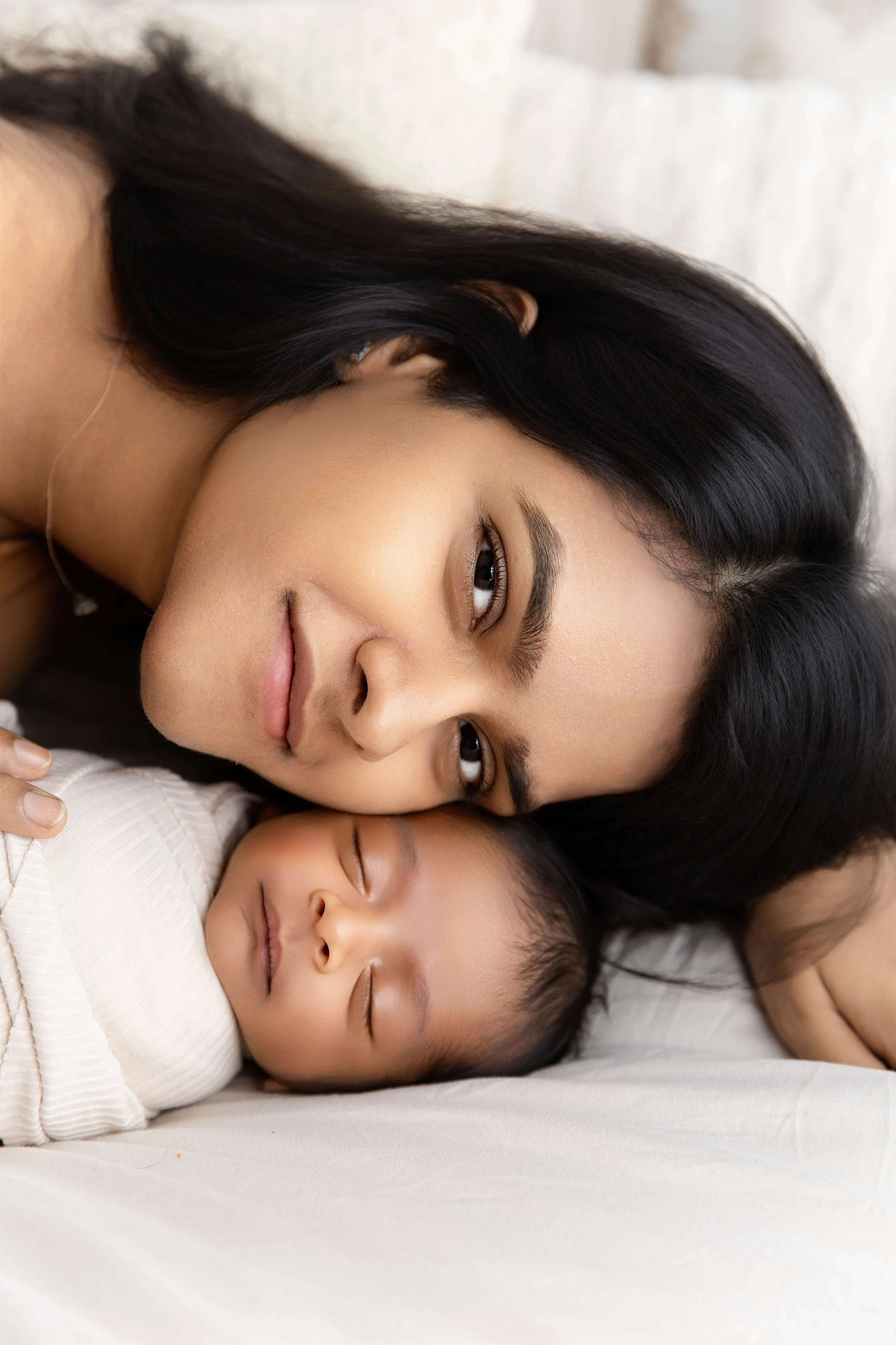 mom putting her cheek against her baby