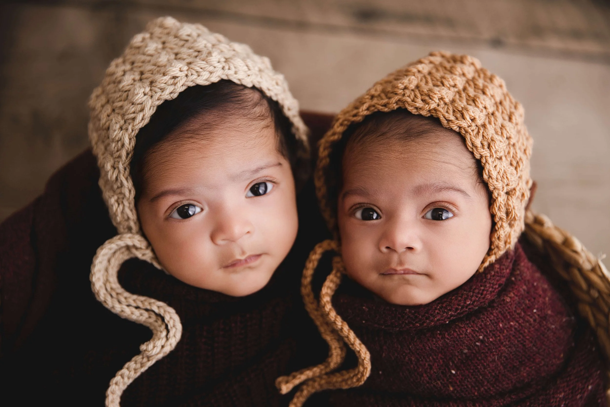 twins wearing knitted bonnets