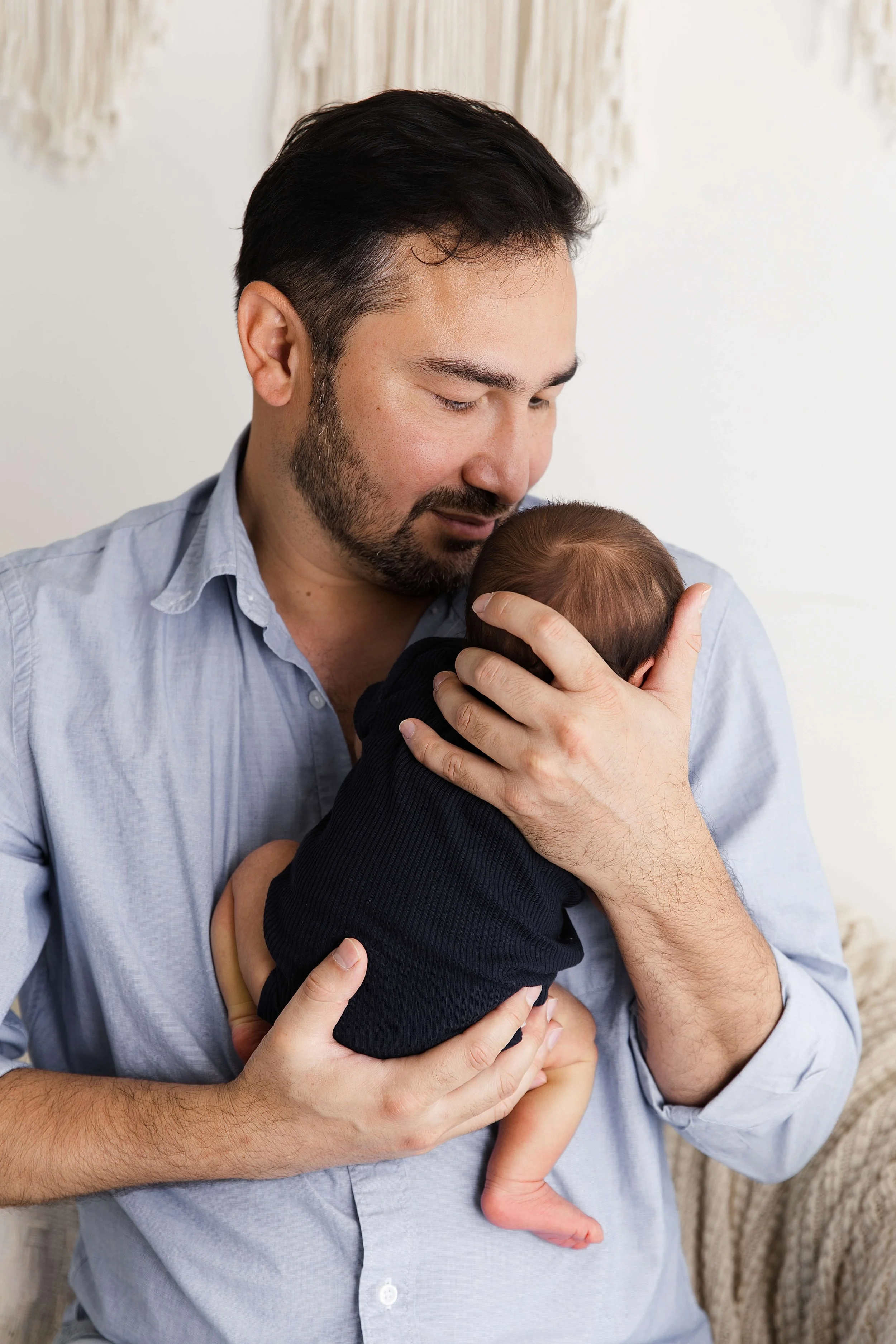 dad holding baby faceless image