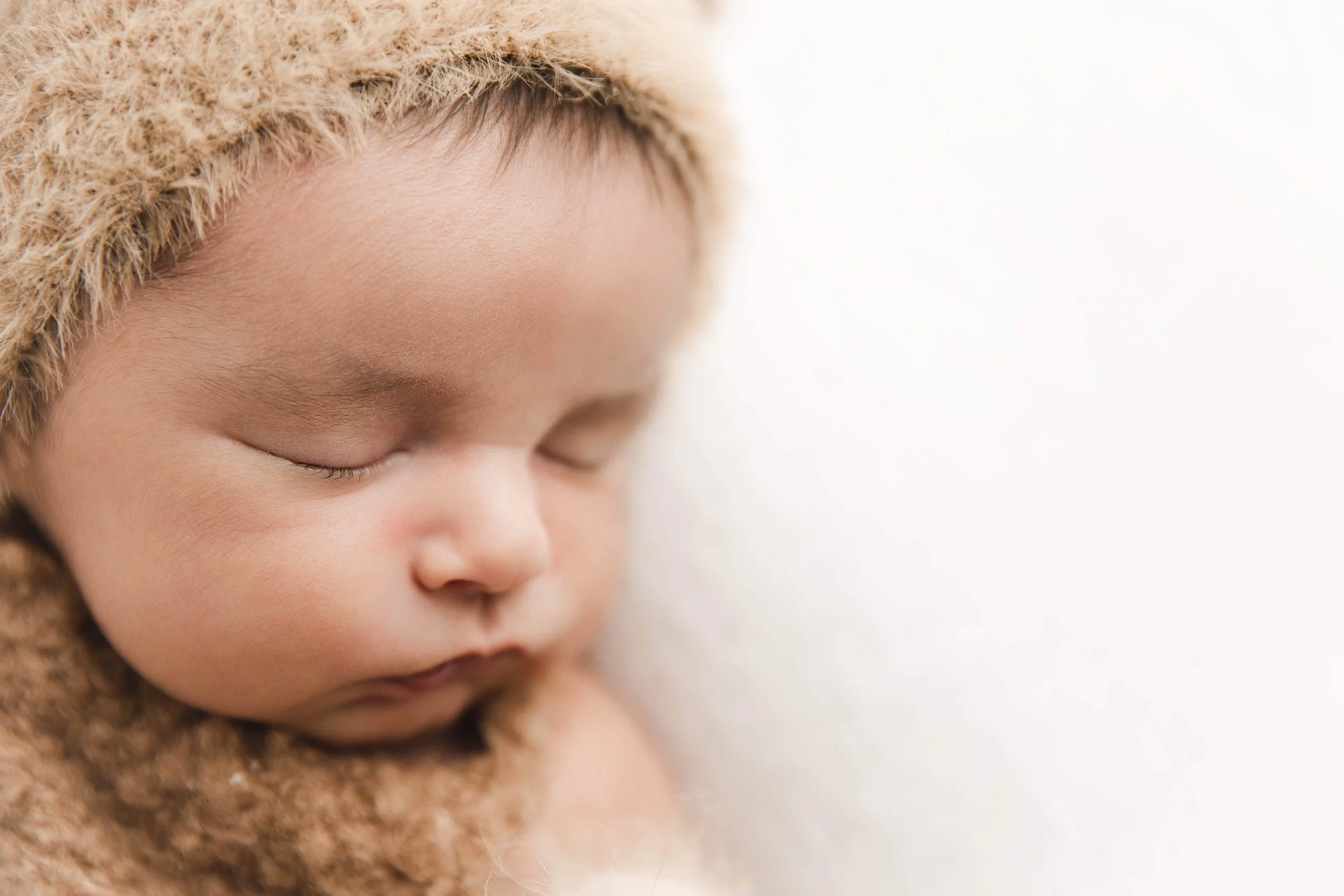 close-up of baby boy in teddy bear hat