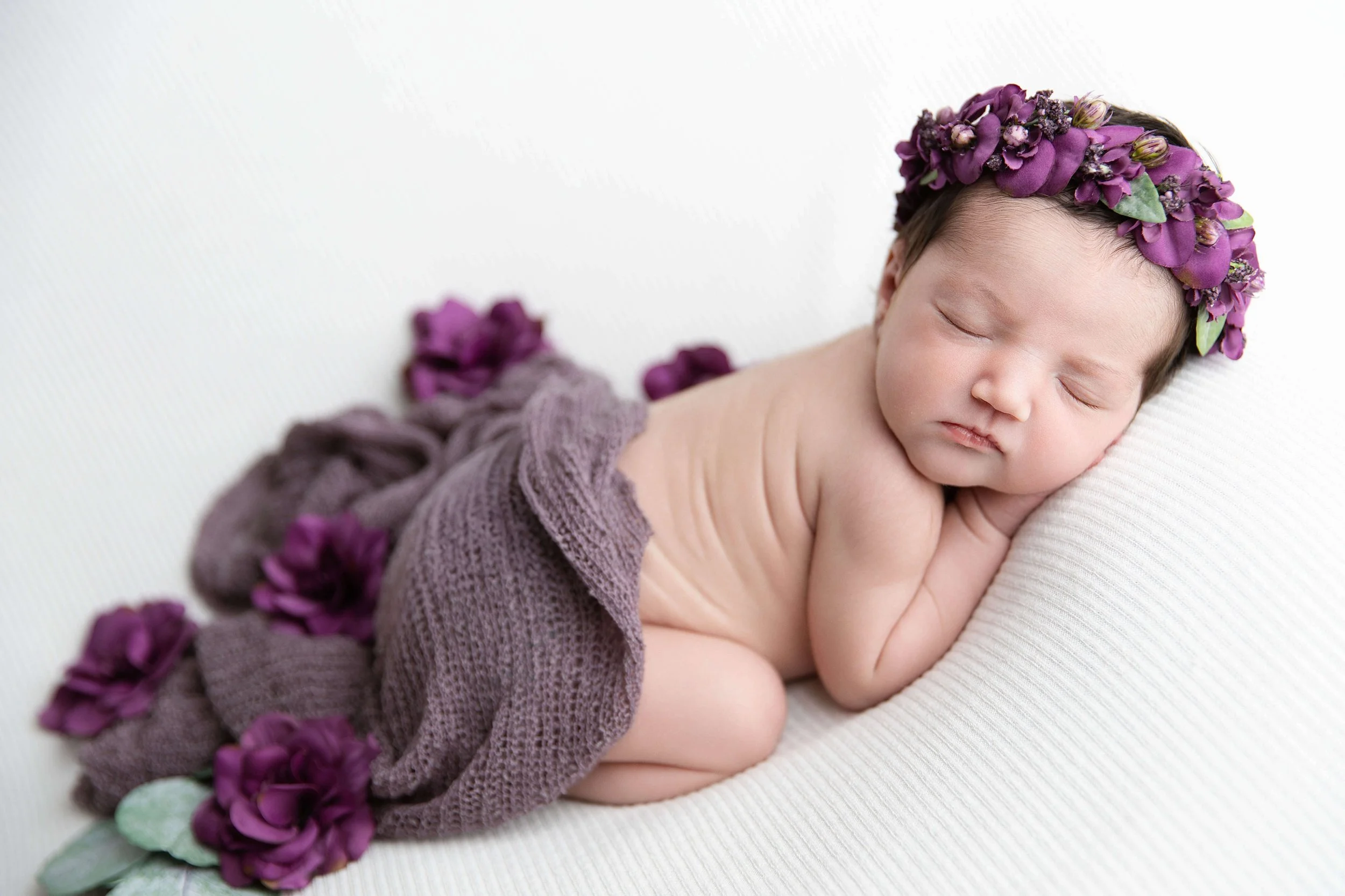 Newborn baby in a bum up pose