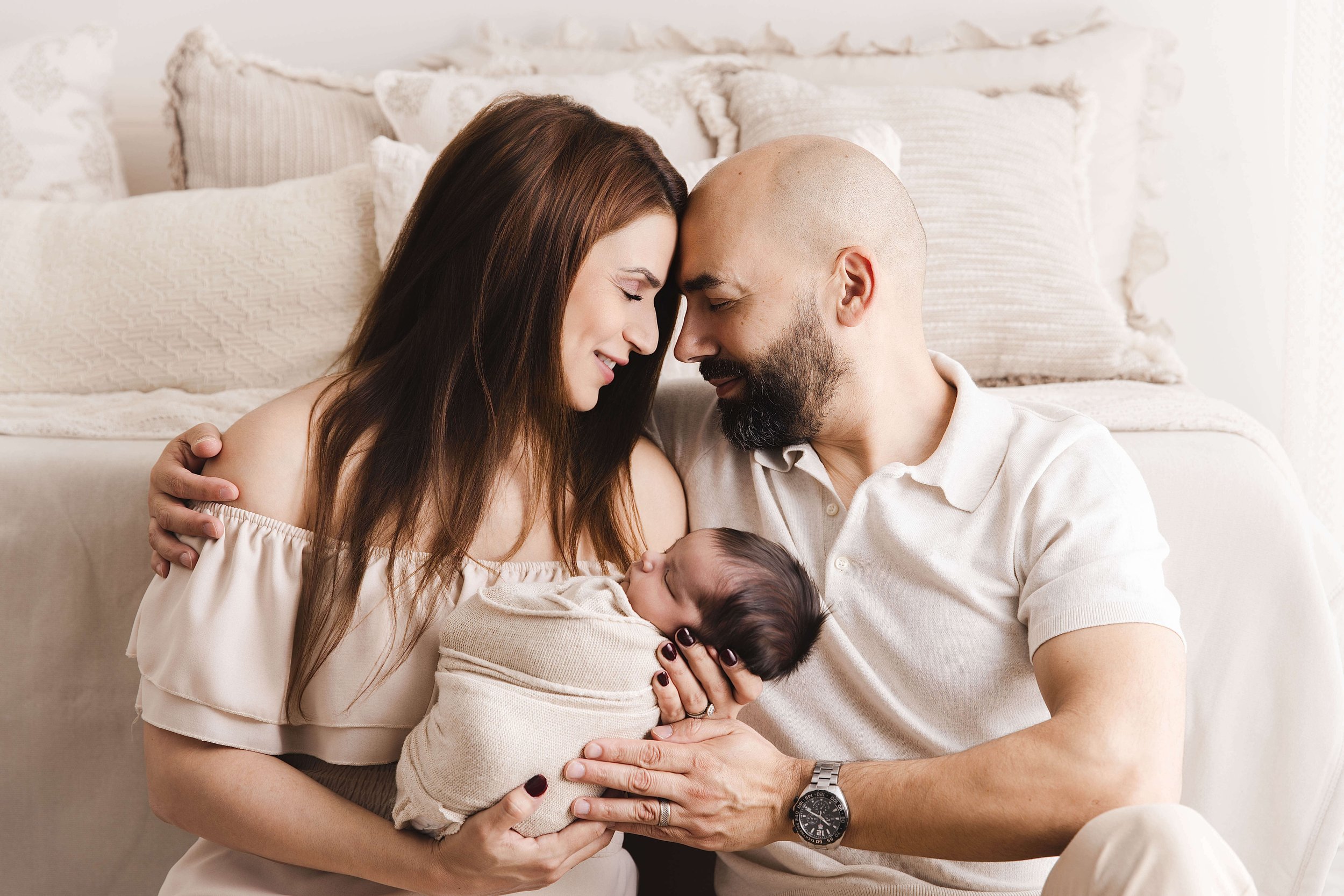 parents cuddling with baby boy