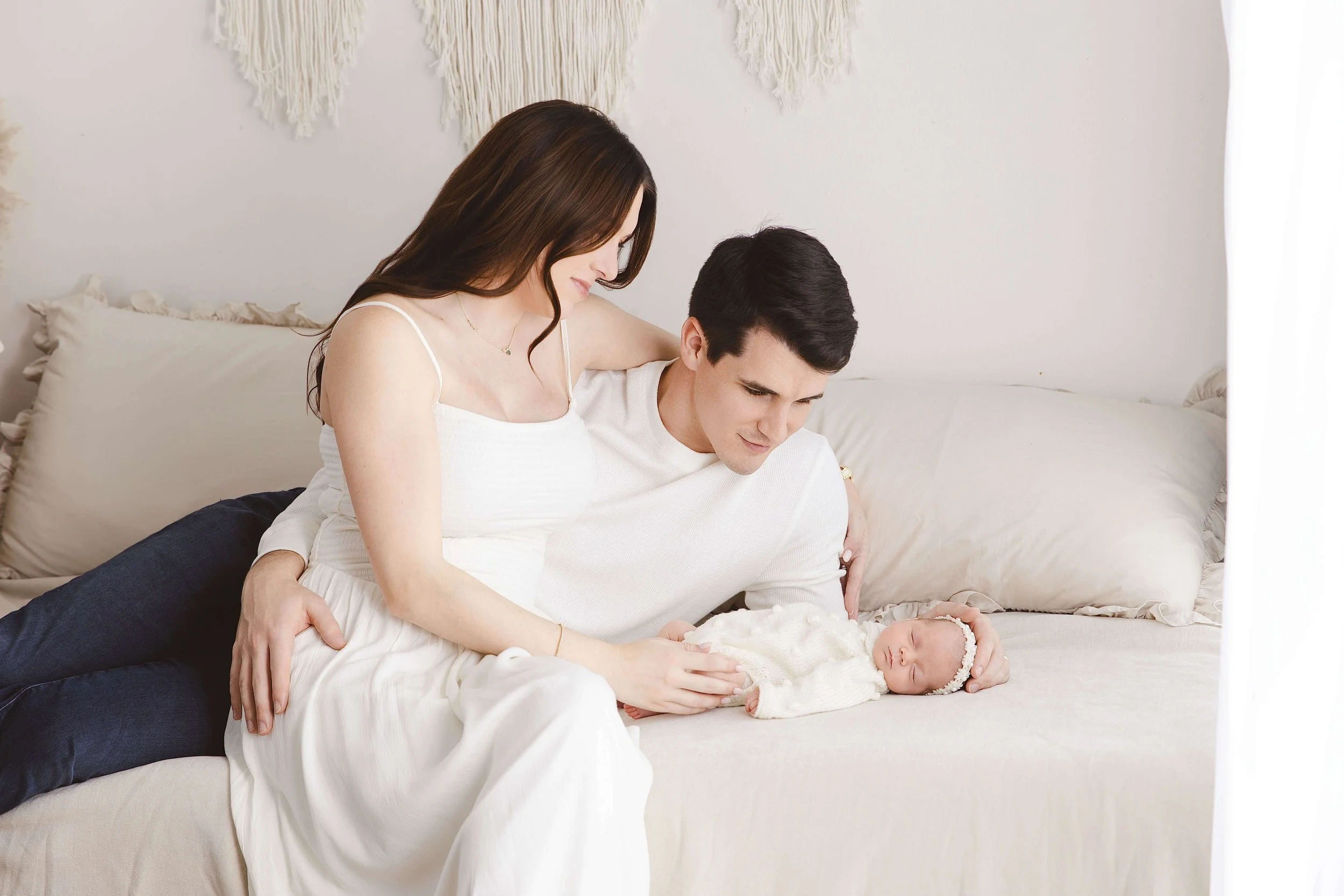 Mother and father having a sweet moment with their newborn baby