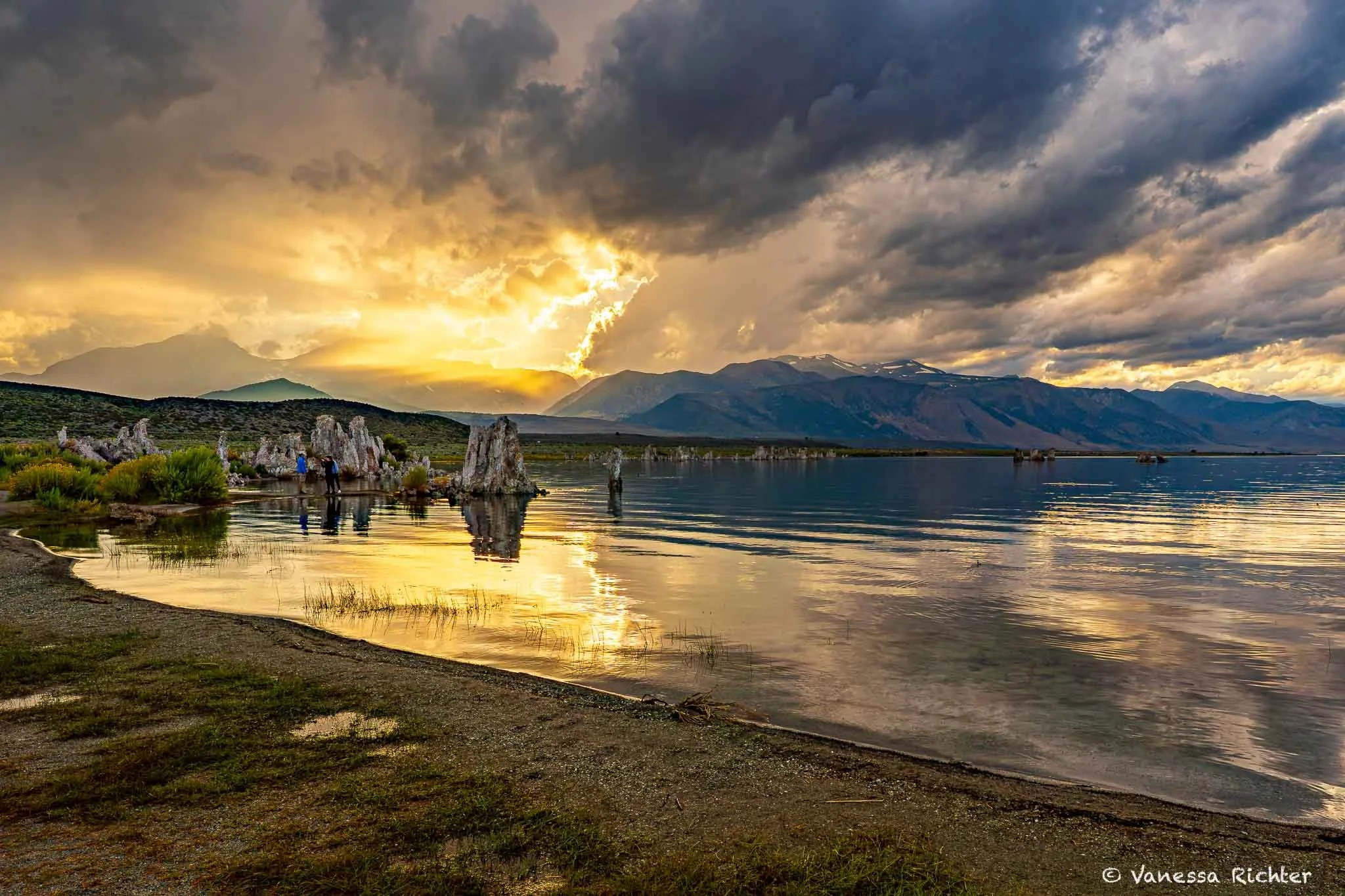 Sunset at Mono Lake reflecting in the lake, with dark clouds mixing with the last glow of the sun.