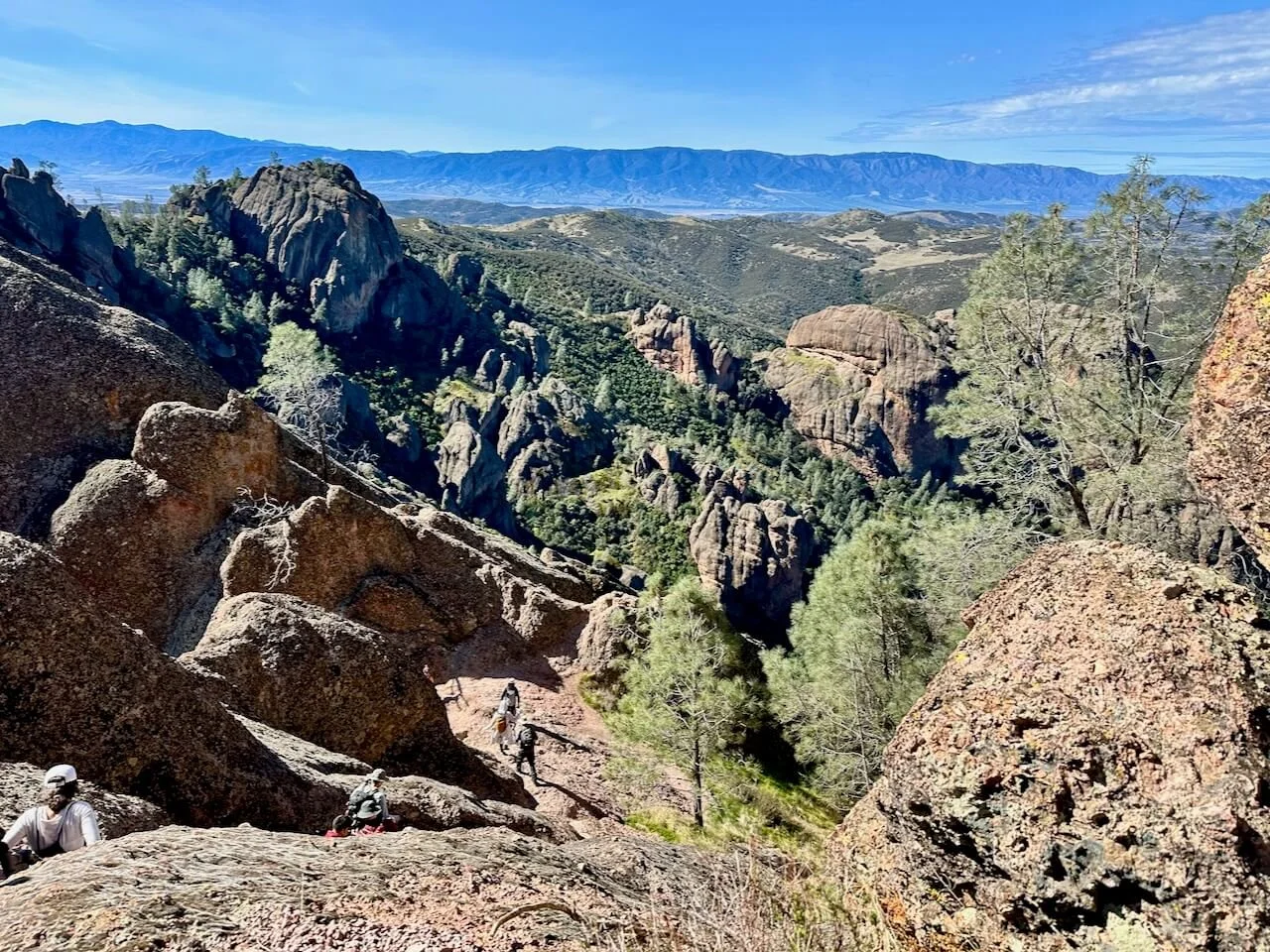 View from the High Peaks Trail in Pinnacles National Park, overlooking volcanic rock formations and chaparral vegetation.