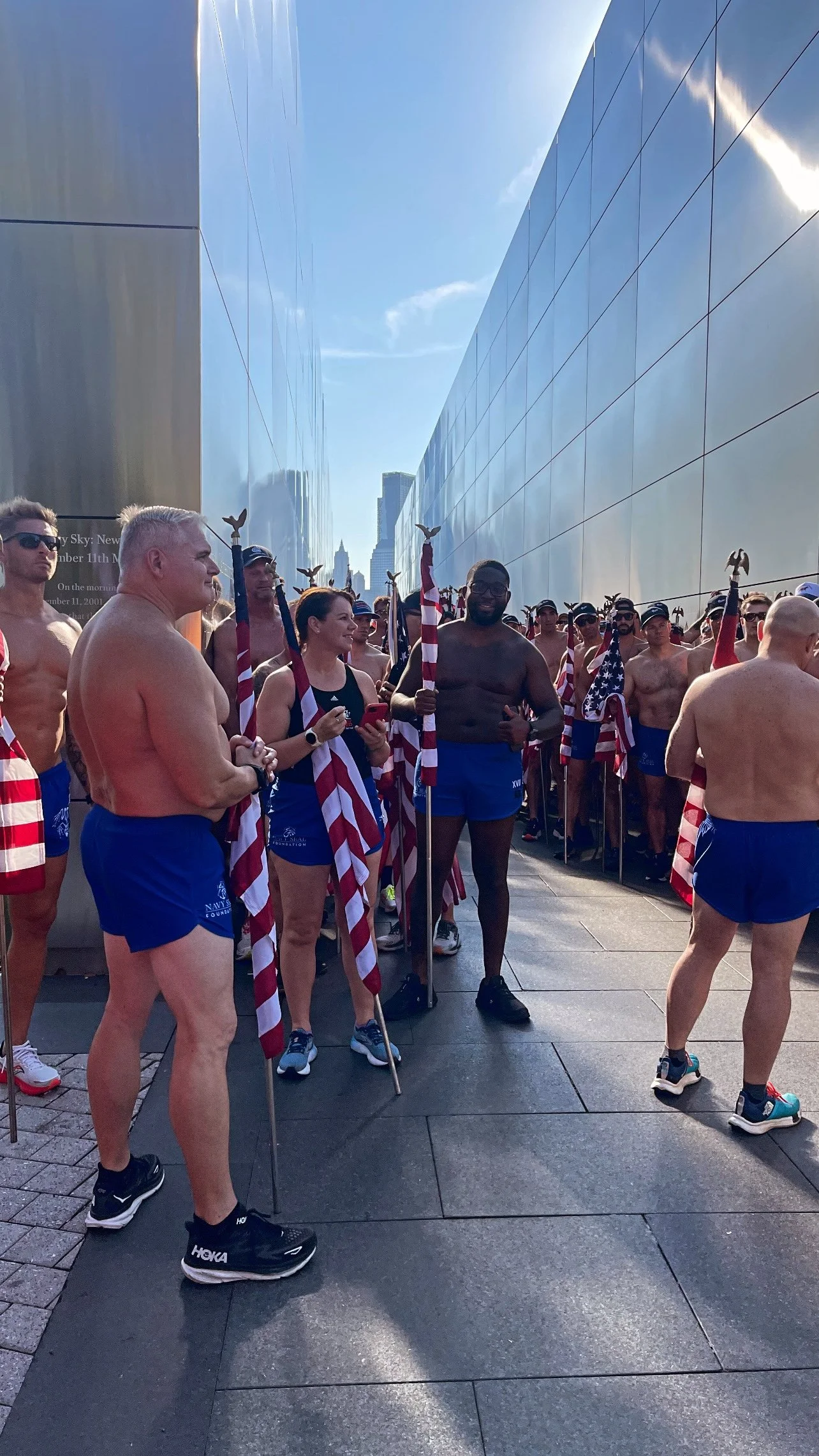 Group of men and women getting ready to run with American Flags for the Navy Seal Foundation Fundraiser
