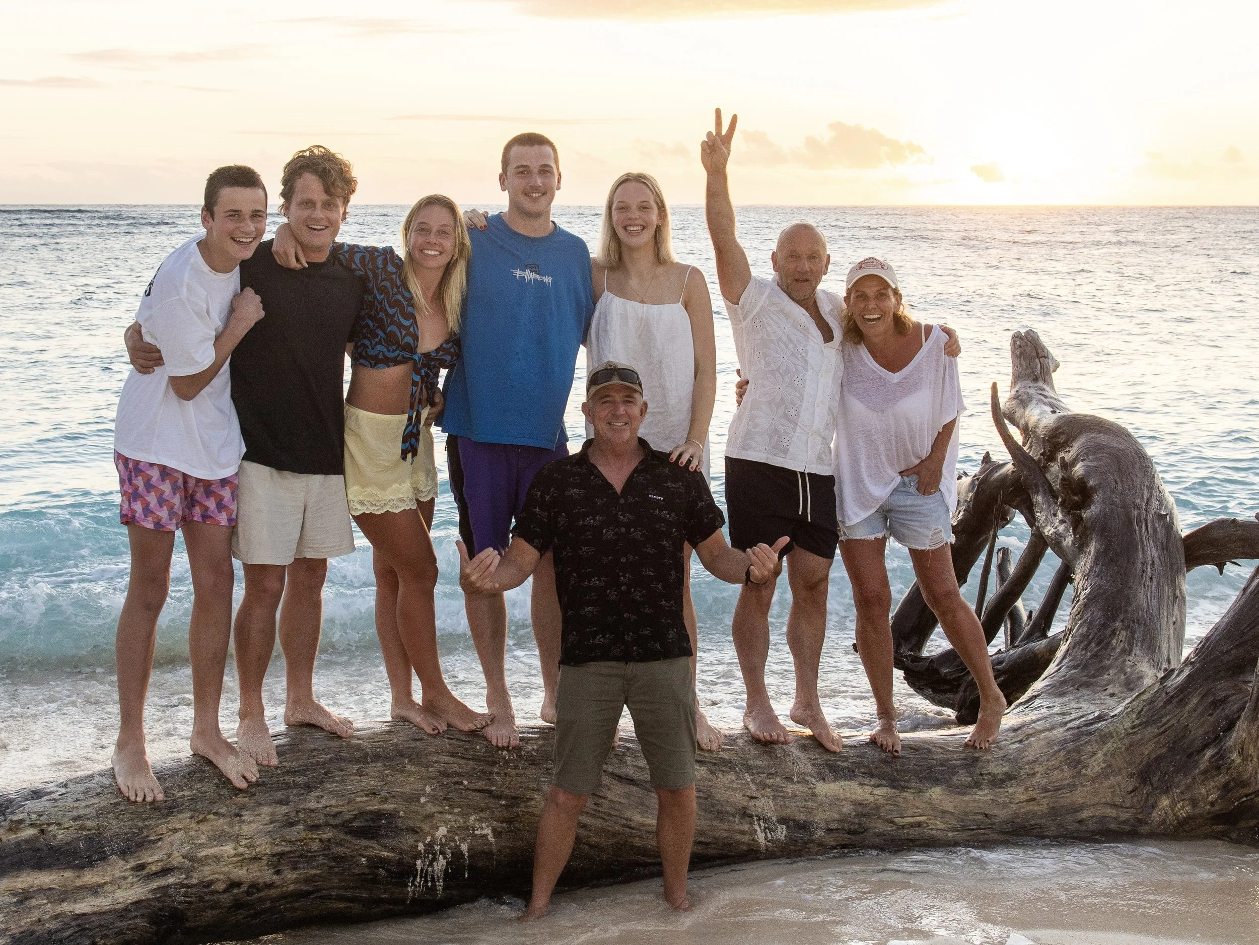 A family photo at sunset with luxury surf guide Chris Prewitt at Namotu Island Resort in Fiji