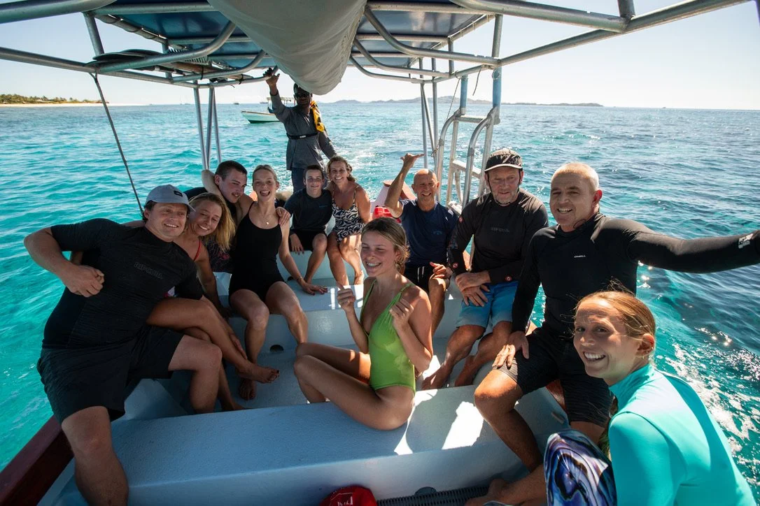 A family on the surf boat with luxury surf guide Chris Prewitt in Fiji