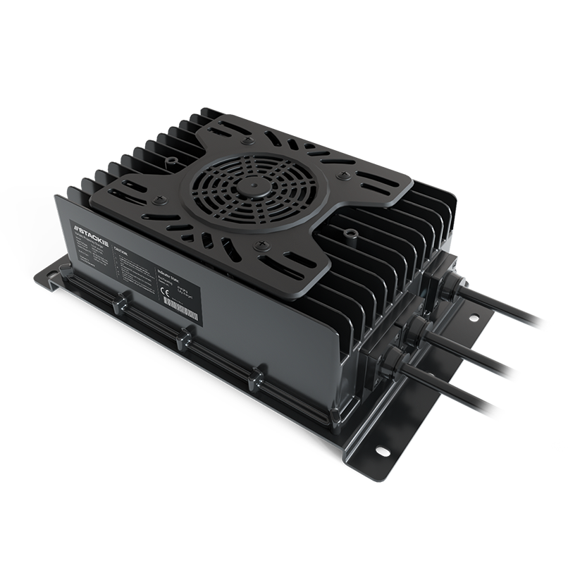 An industrial electronic device, possibly a power supply or a cooling unit, with black fins, a circular fan cover, and cables attached, mounted on a metal base.