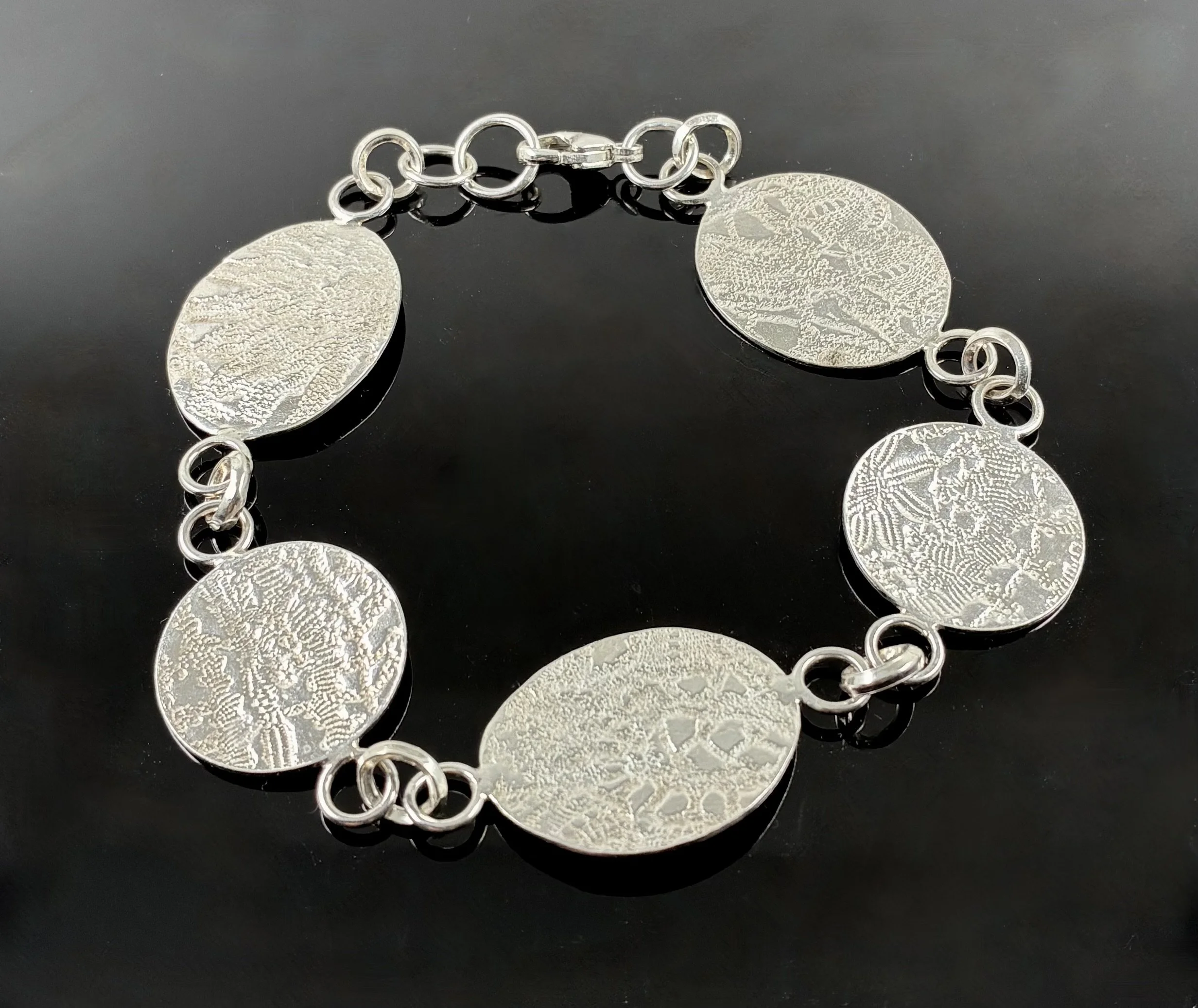 (1) Sterling Silver bracelet with embossed discs