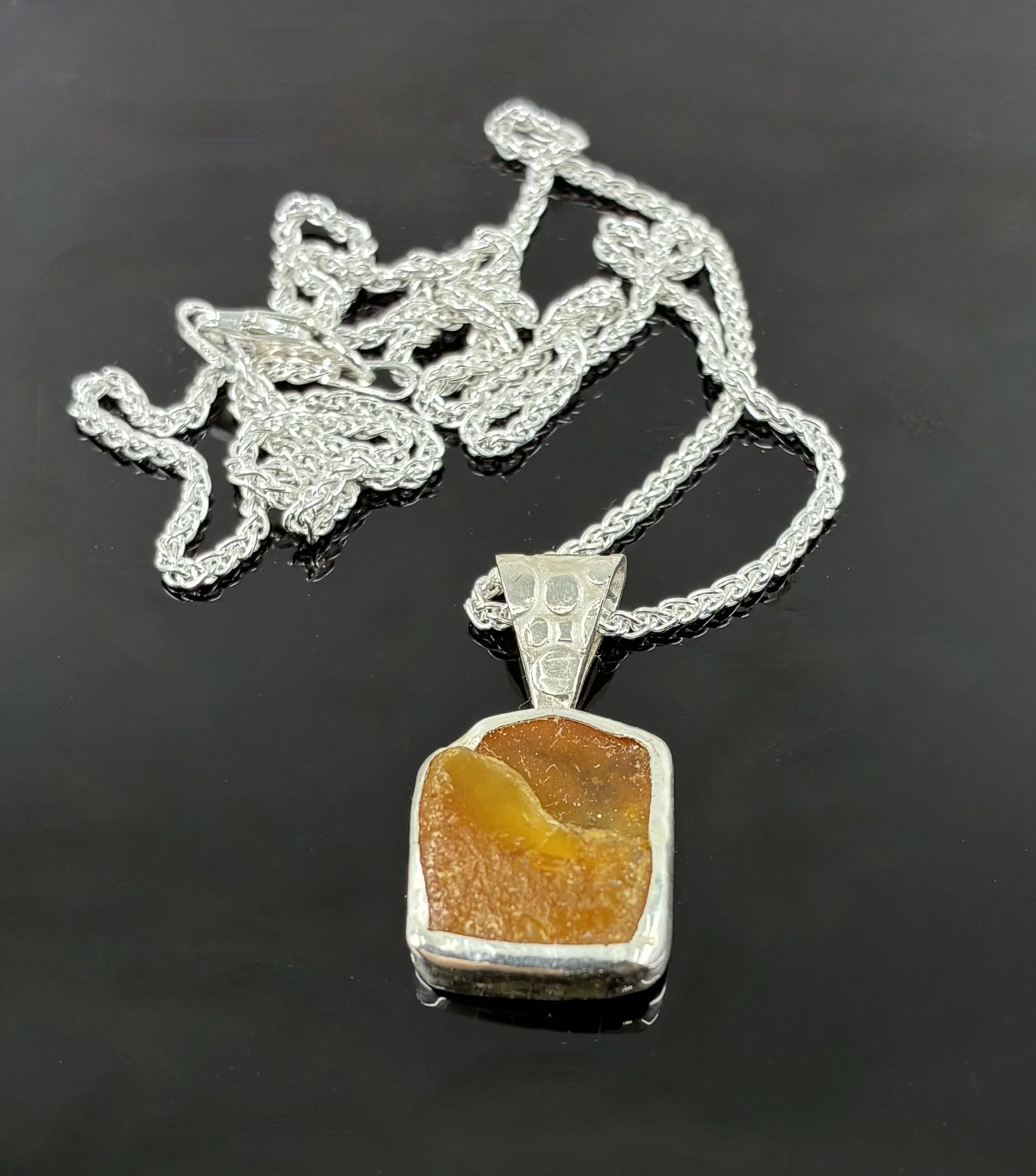 (56) Sterling Silver and Norfolk Amber Pendant