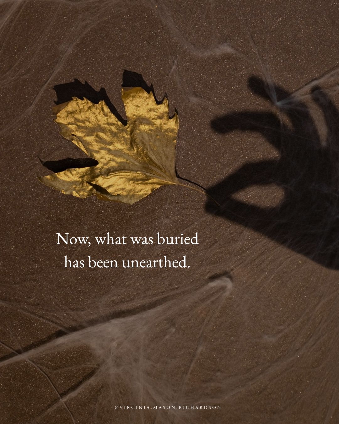Image of a golden leaf being found by a shadow hand (Copy) (Copy)