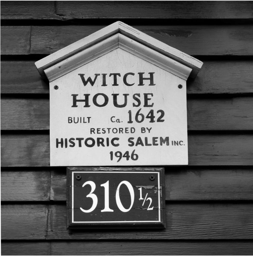 New England sign that reads "Witch House Restored by Historic Salem"