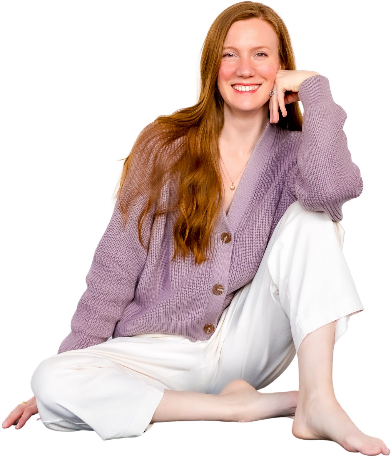 Author Virginia Mason Richardson Smiling in purple sweater, long red hair cascading over her shoulder