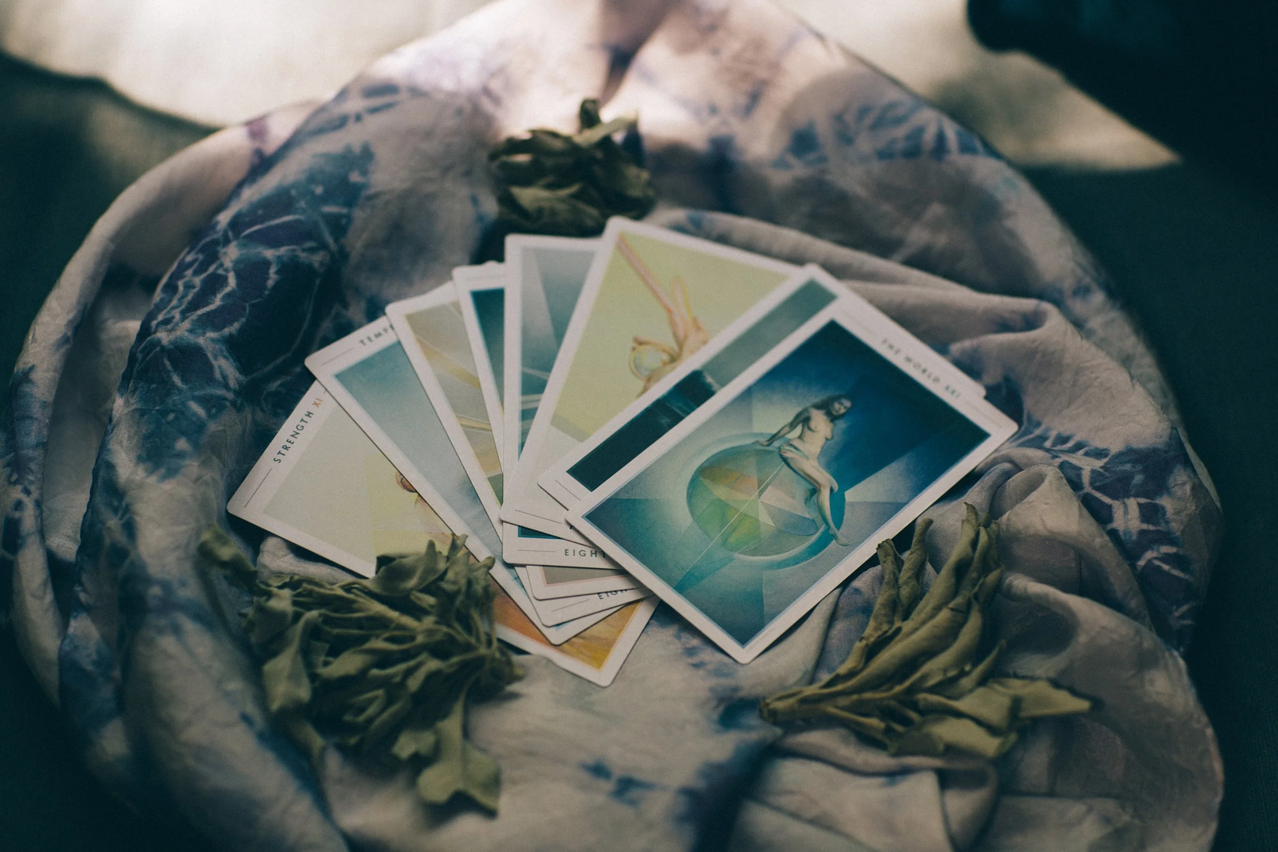 Picture of cards from the Fountain Tarot Deck with the World on top