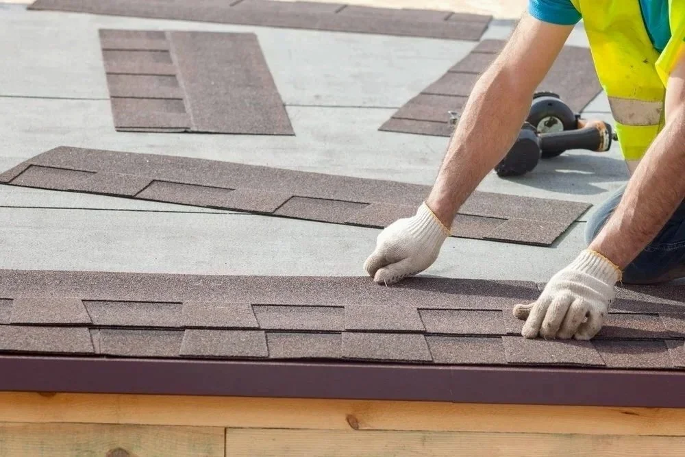 Installing asphalt shingles for new residential roof installation in Calgary