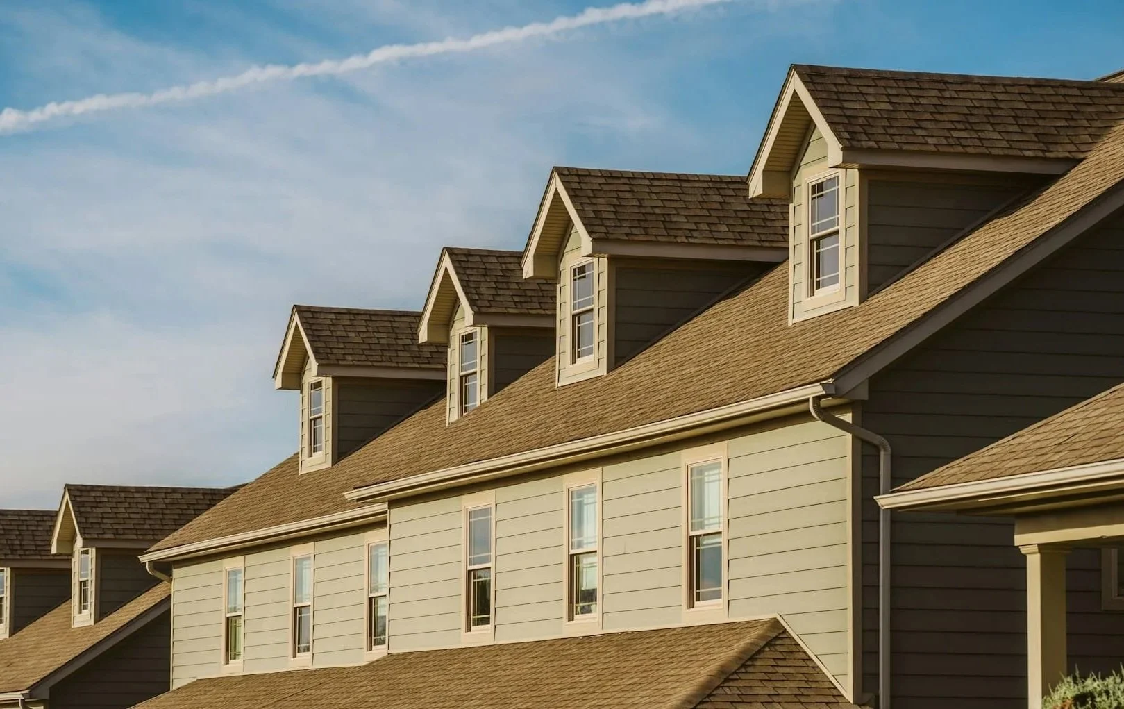 Asphalt shingle roof with dormers on a Calgary home, representing residential roof maintenance and upkeep