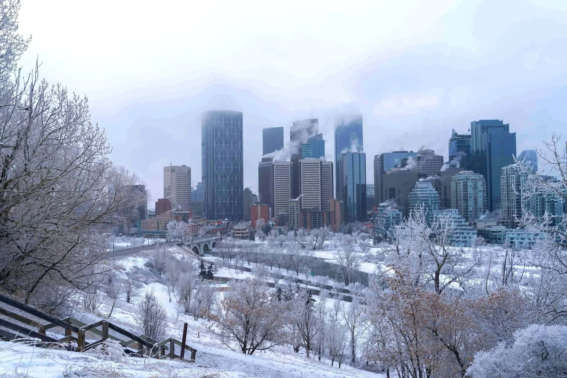 Downtown Calgary covered in snow during winter with commercial buildings and surrounding properties