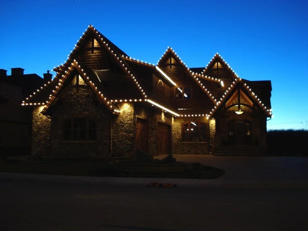 Professional residential Christmas light installation in Calgary with warm white C9 lights on steep rooflines