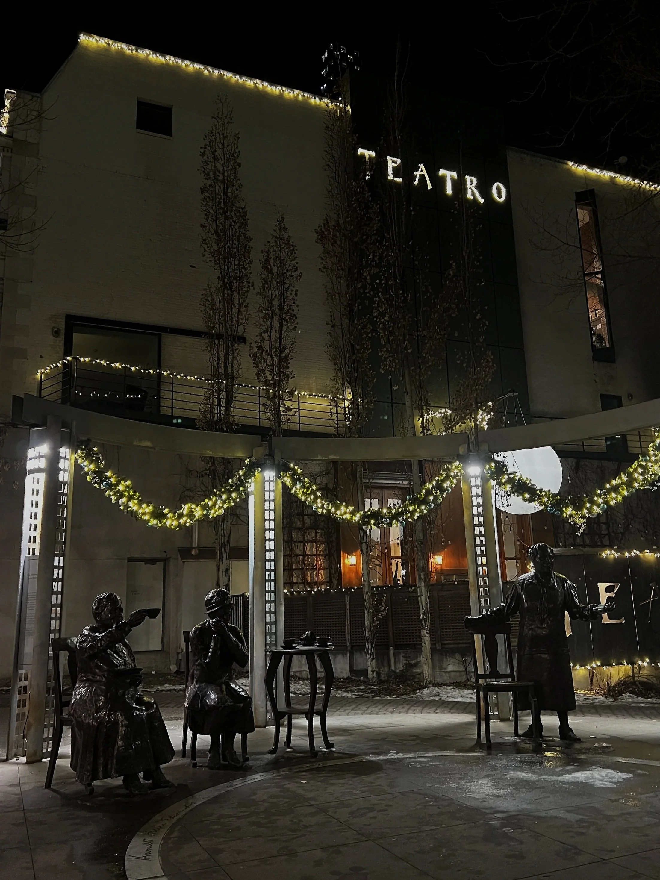 Custom commercial holiday lighting installation at Teatros Restaurant in Calgary with warm white roofline lights and decorative garland