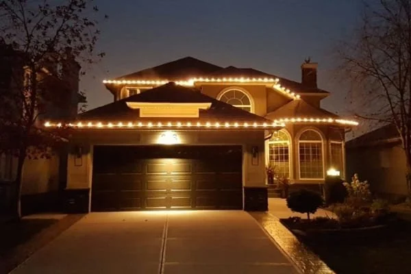 Professional residential Christmas light installation in Calgary with warm white C9 lights on roofline