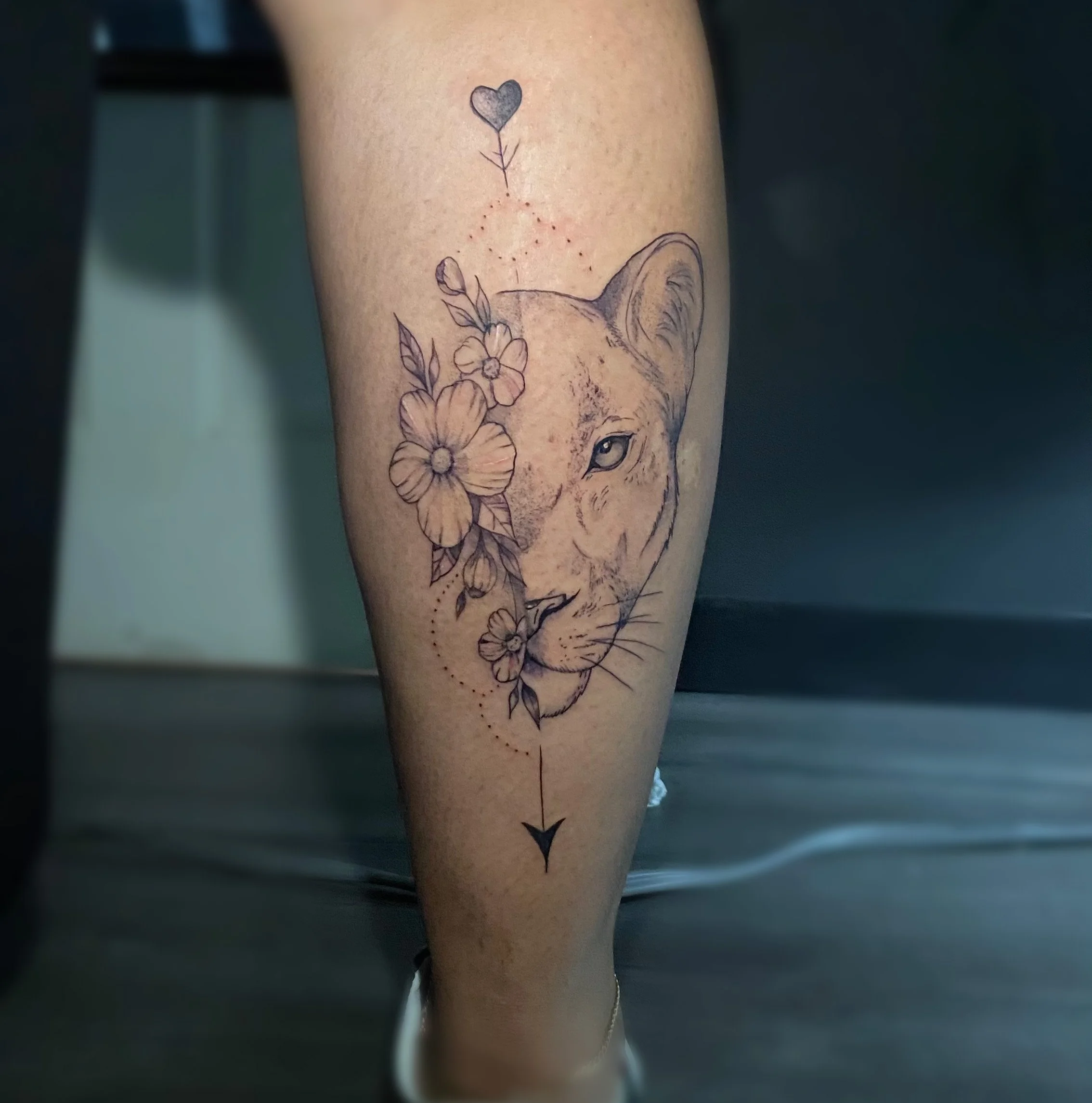 Minimal lion and flower thin line tattoo