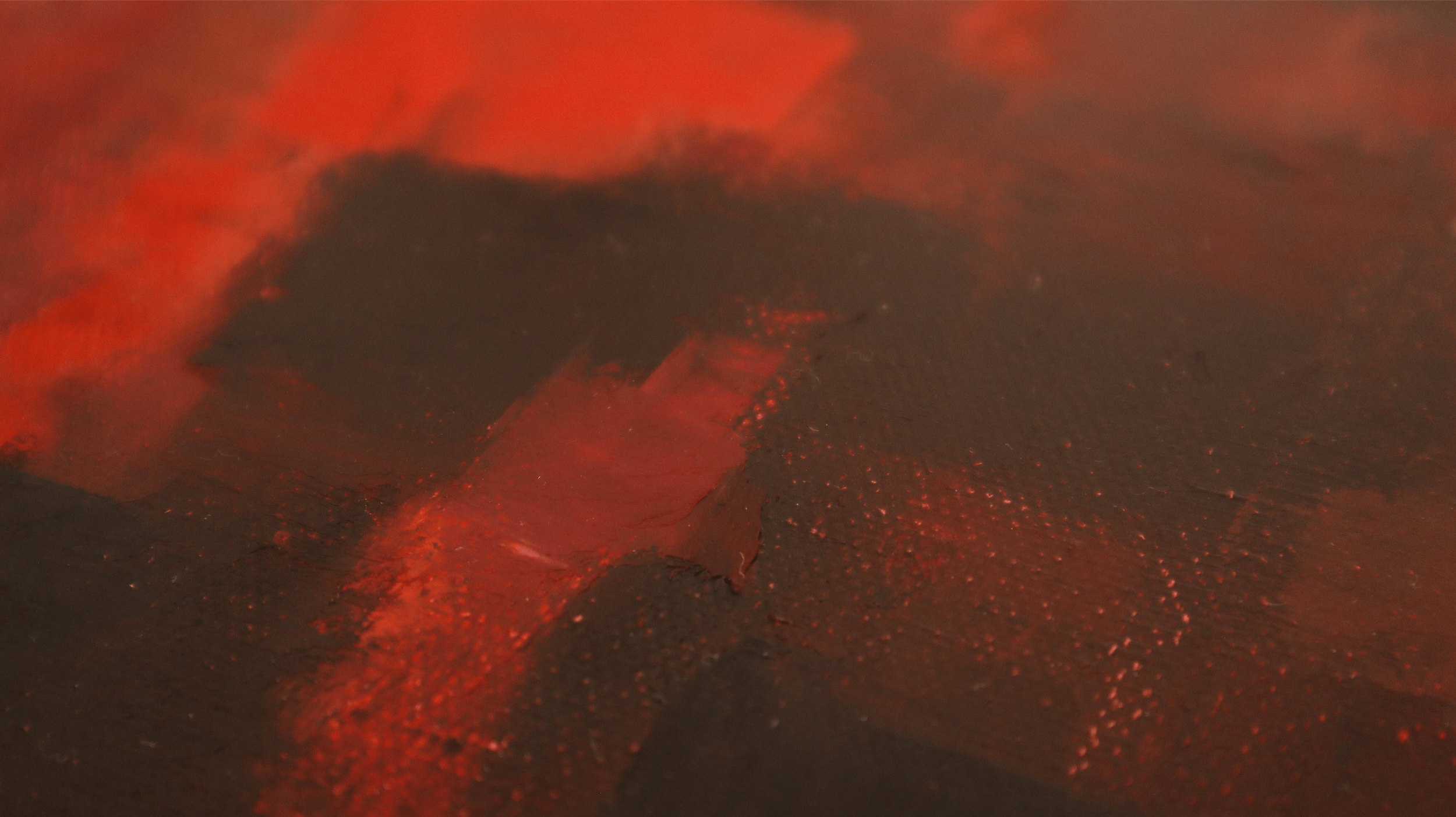 Side-view close-up of abstract oil painting surface showing details and texture