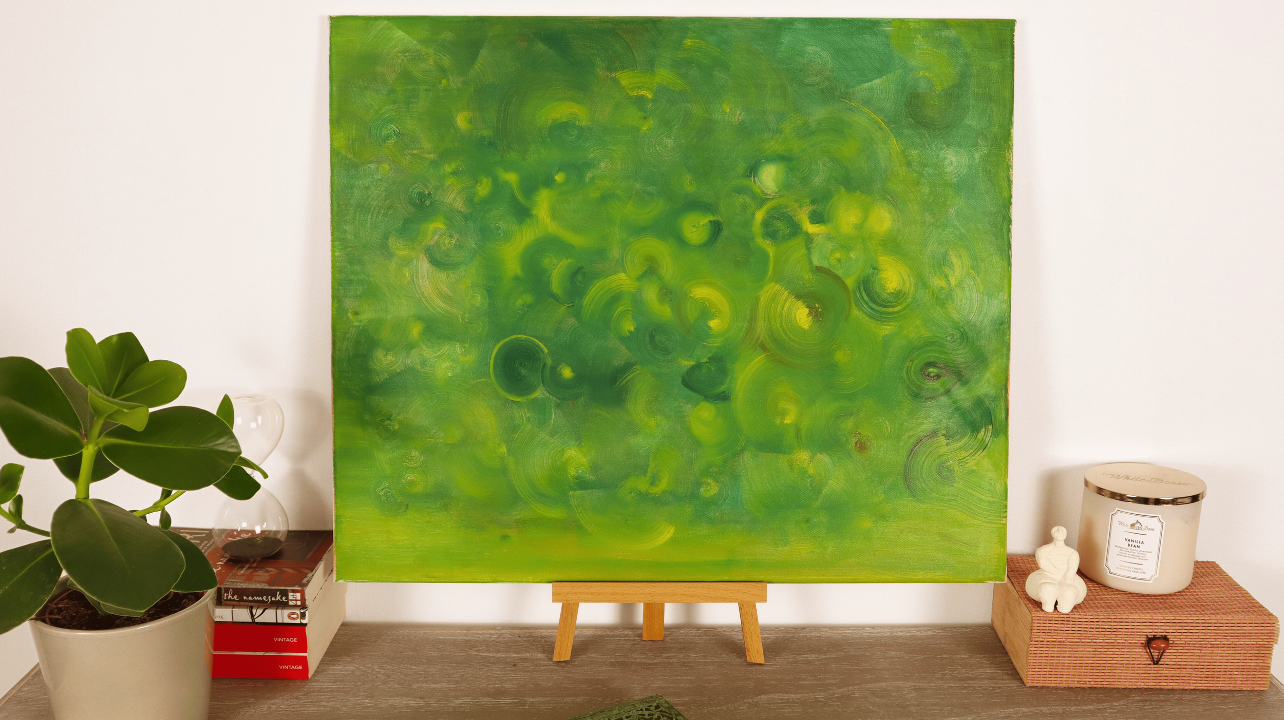Contemporary abstract green painting displayed in a modern minimalist interior