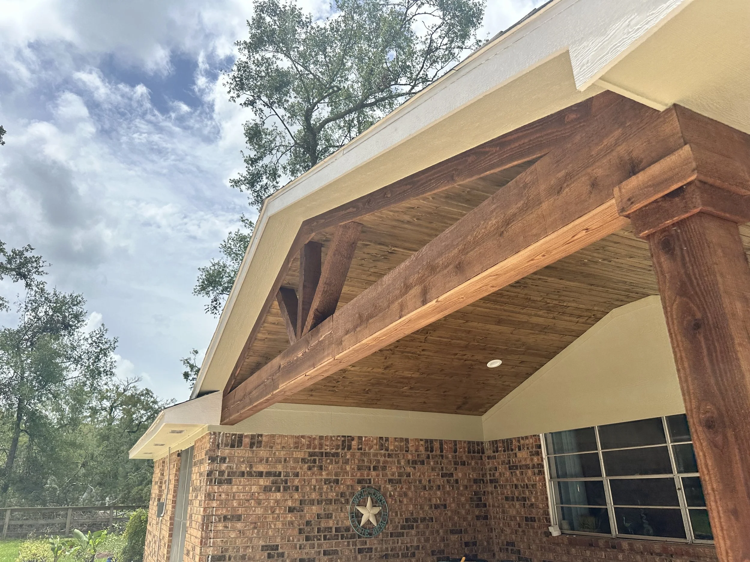 Stained cedar tongue-and-groove ceiling on a 13x20 patio cover tied into the roofline