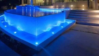 Color-changing LED pool lighting at dusk