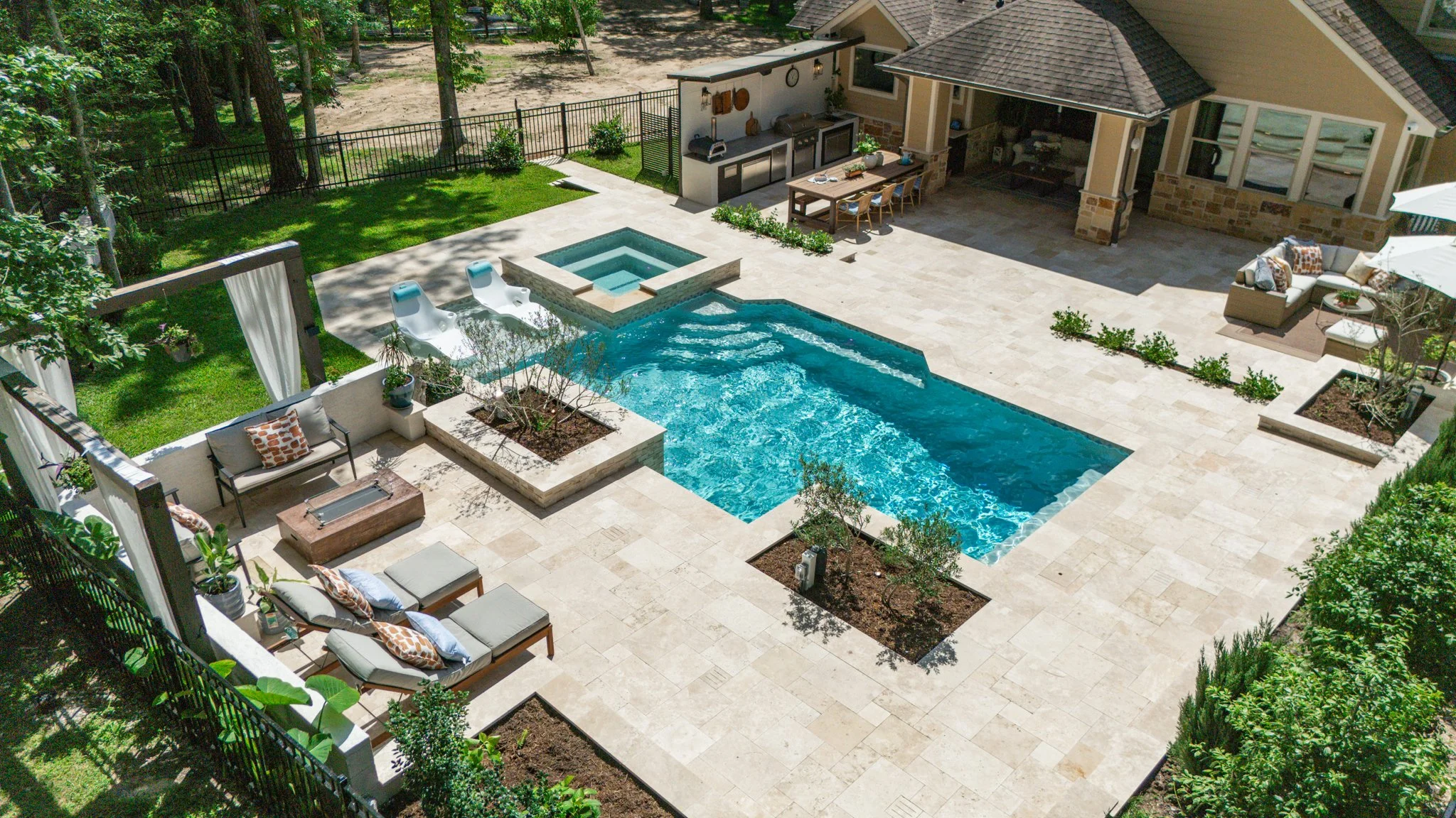 Wide view of pool, raised spa and pine backdrop in Willowridge Estates